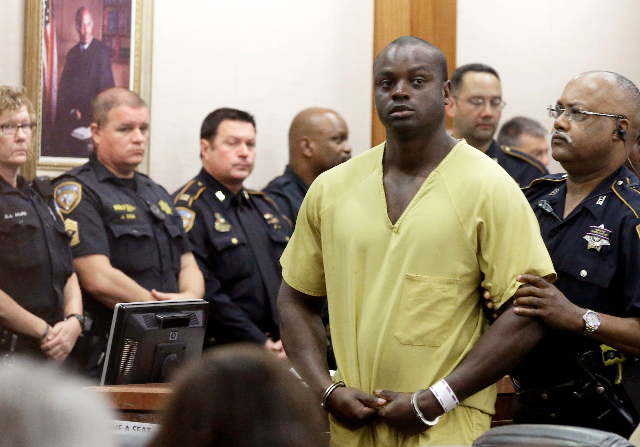 Shannon Miles is escorted out of a Houston courtroom on Monday.