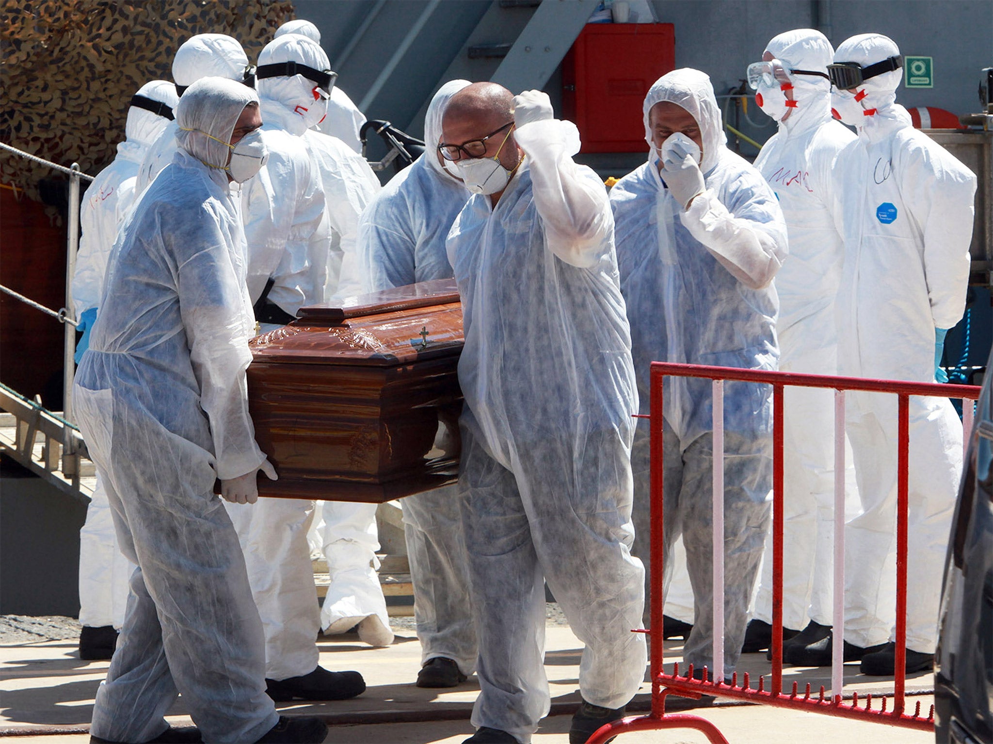 Italian soldiers at Messina in Sicily carry one of the 13 coffins of migrants who died attempting to cross the Mediterranean in July