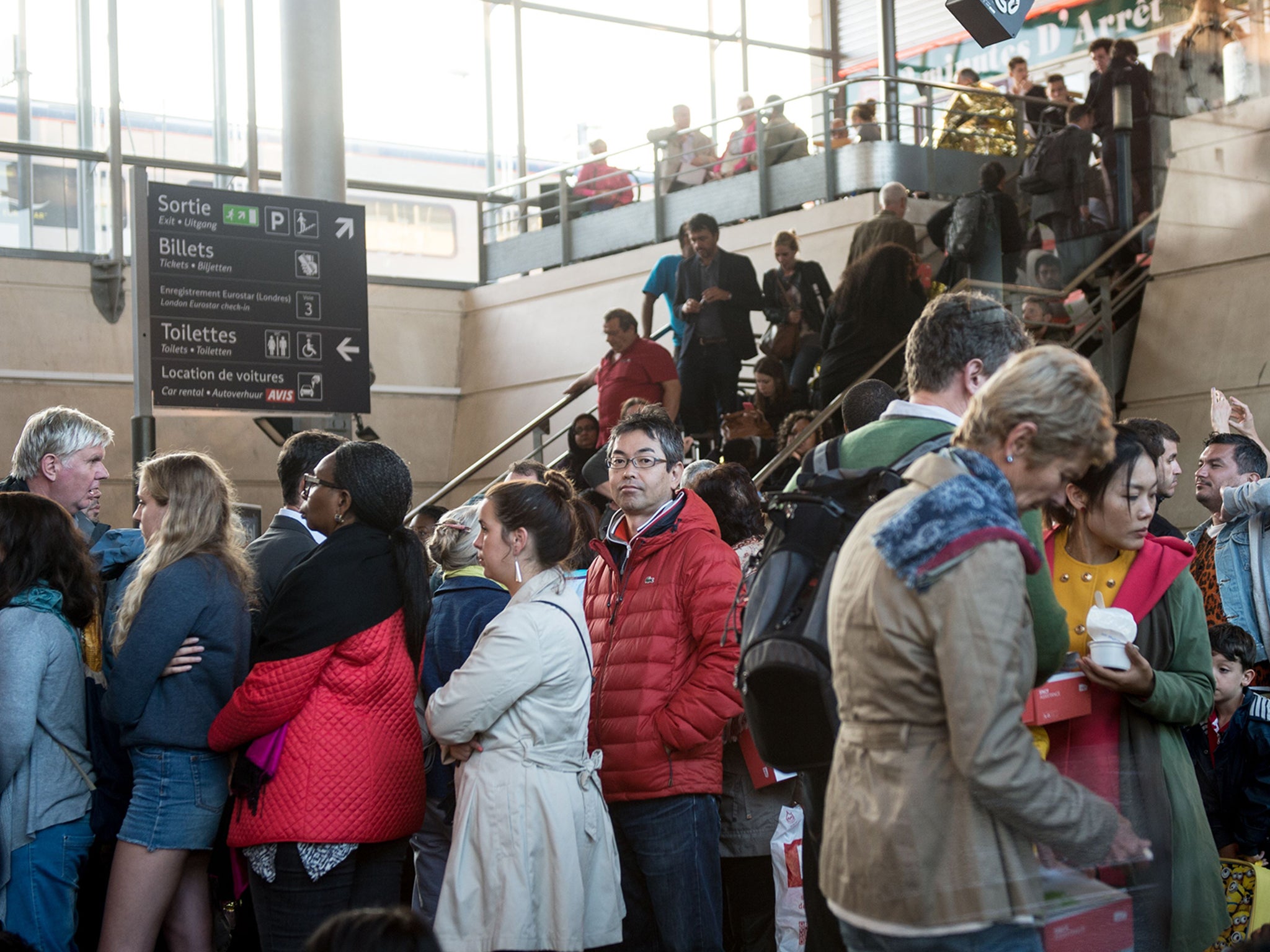 Stranded passengers wait at the Calais-Frethun train station in northern France to cross to the United Kingdom