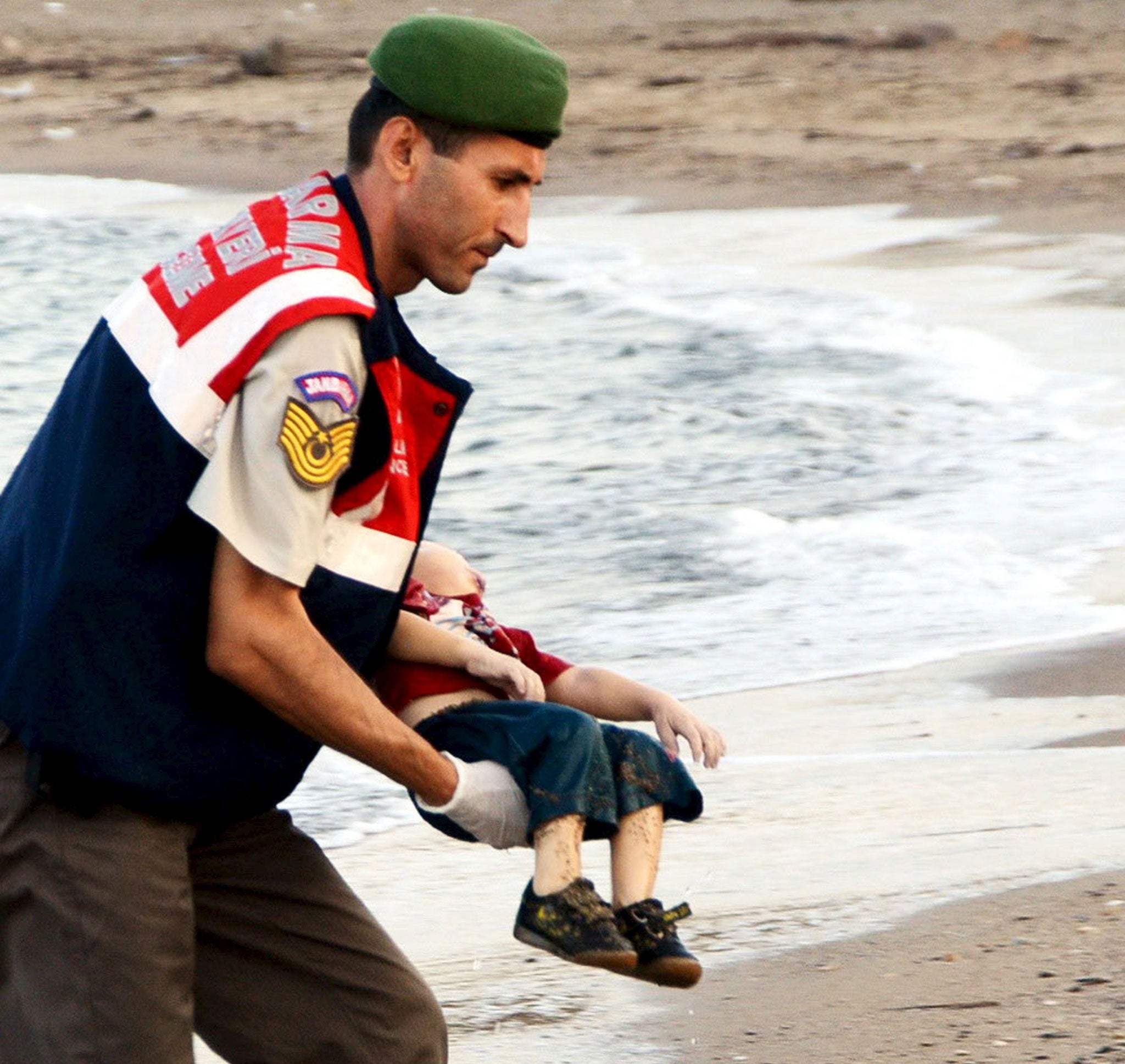 A Turkish rescue worker carries the young boy, who drowned during a failed attempt to sail to the Greek island of Kos (Reuters)