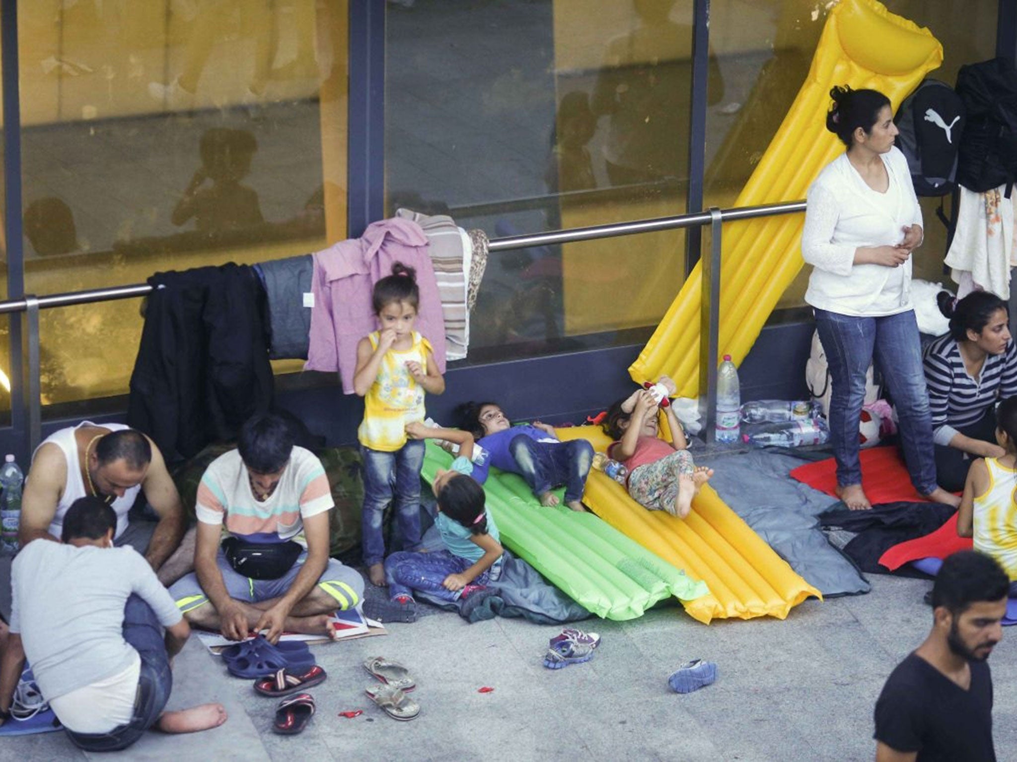 Refugees are pictured by their sparse belongings at Keleti (Image: Reuters)