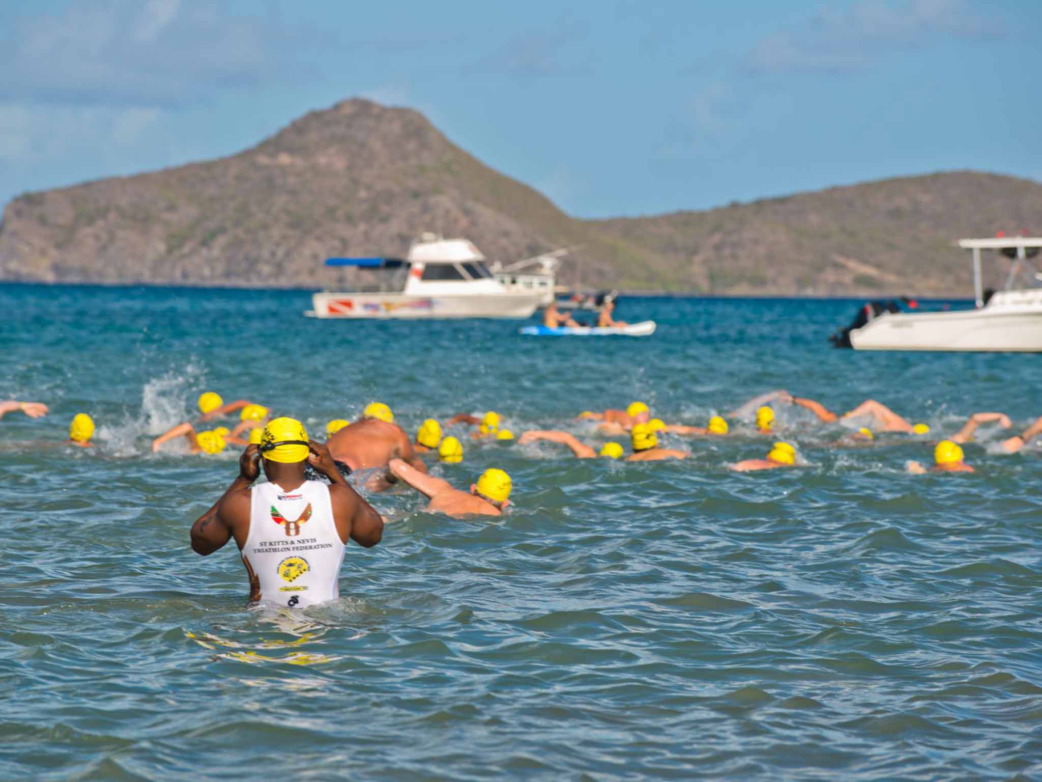 Cap it off: swimmers enter the channel