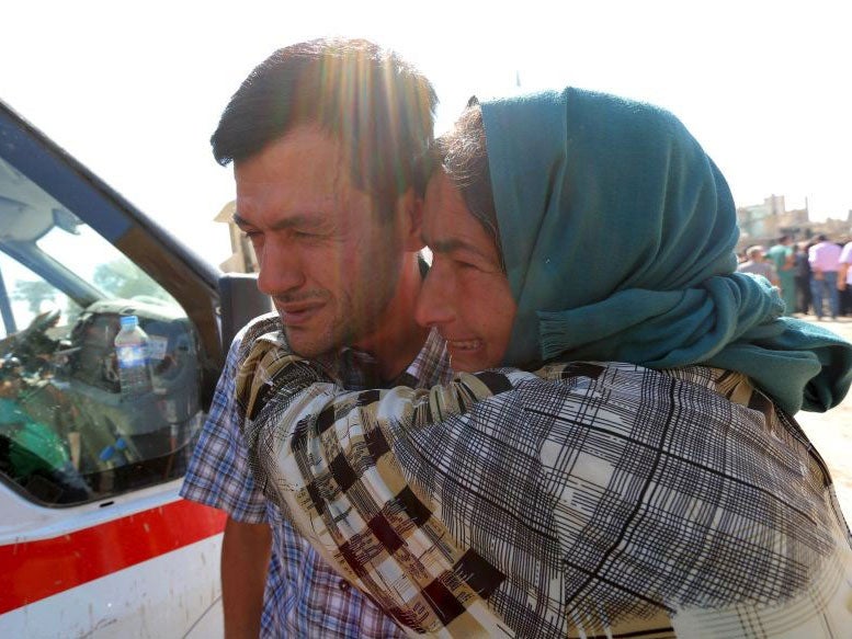 Aylan's father, Abdullah Kurdi, with a relative at the funeral