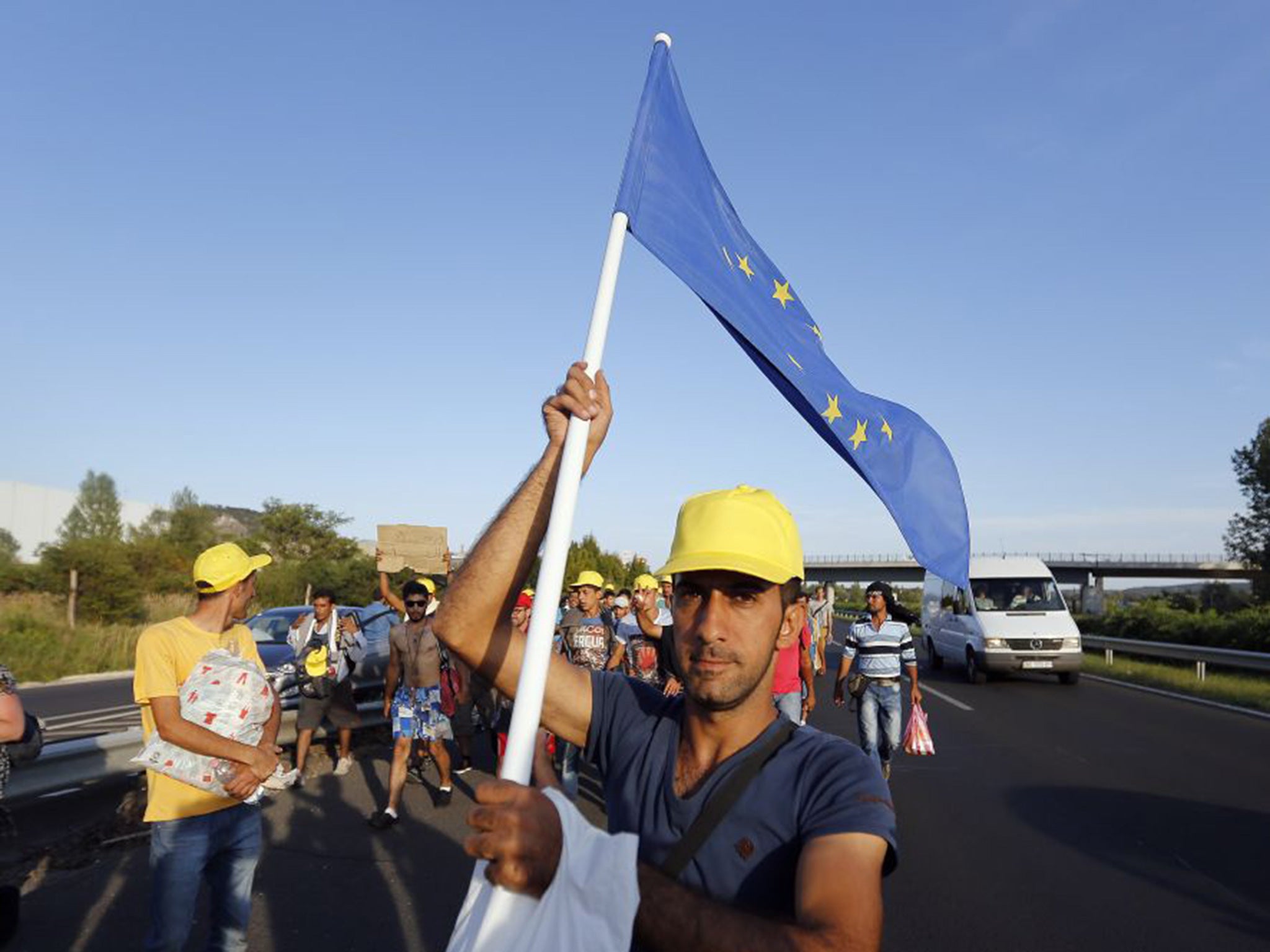 Migrants walk out of Budapest, Hungary, Friday, Sept. 4, 2015.