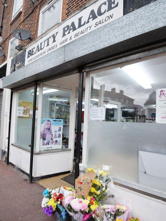 Floral tributes outside the workplace of a relative of Shaquan Fearon, who was stabbed in Brockley, south east London.