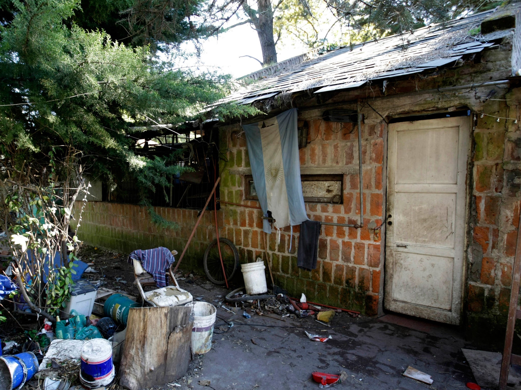 An Argentine flag hangs from the home where Eduardo Oviedo is accused of keeping his wife and autistic son locked up for years