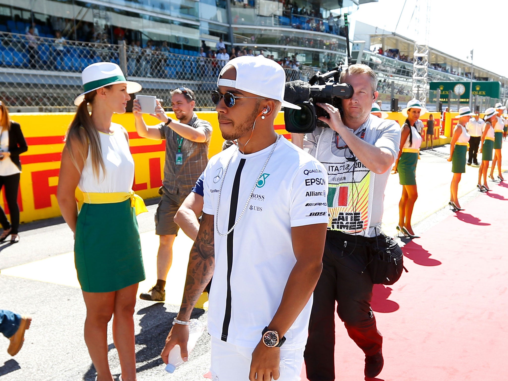 Lewis Hamilton arrives at the Italian Grand Prix in Monza - before leaving his baseball cap on for Justin Wilson's minute's silence