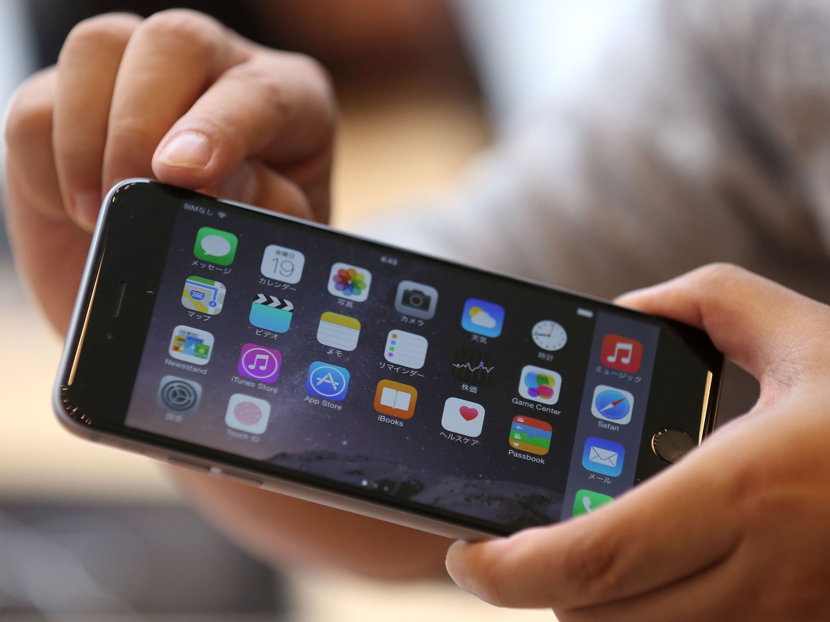 A customer looks at the new Iphone 6 Plus at the launch of the new Apple iPhone 6 and iPhone 6 plus at the Apple Omotesando store on September 19, 2014 in Tokyo, Japan