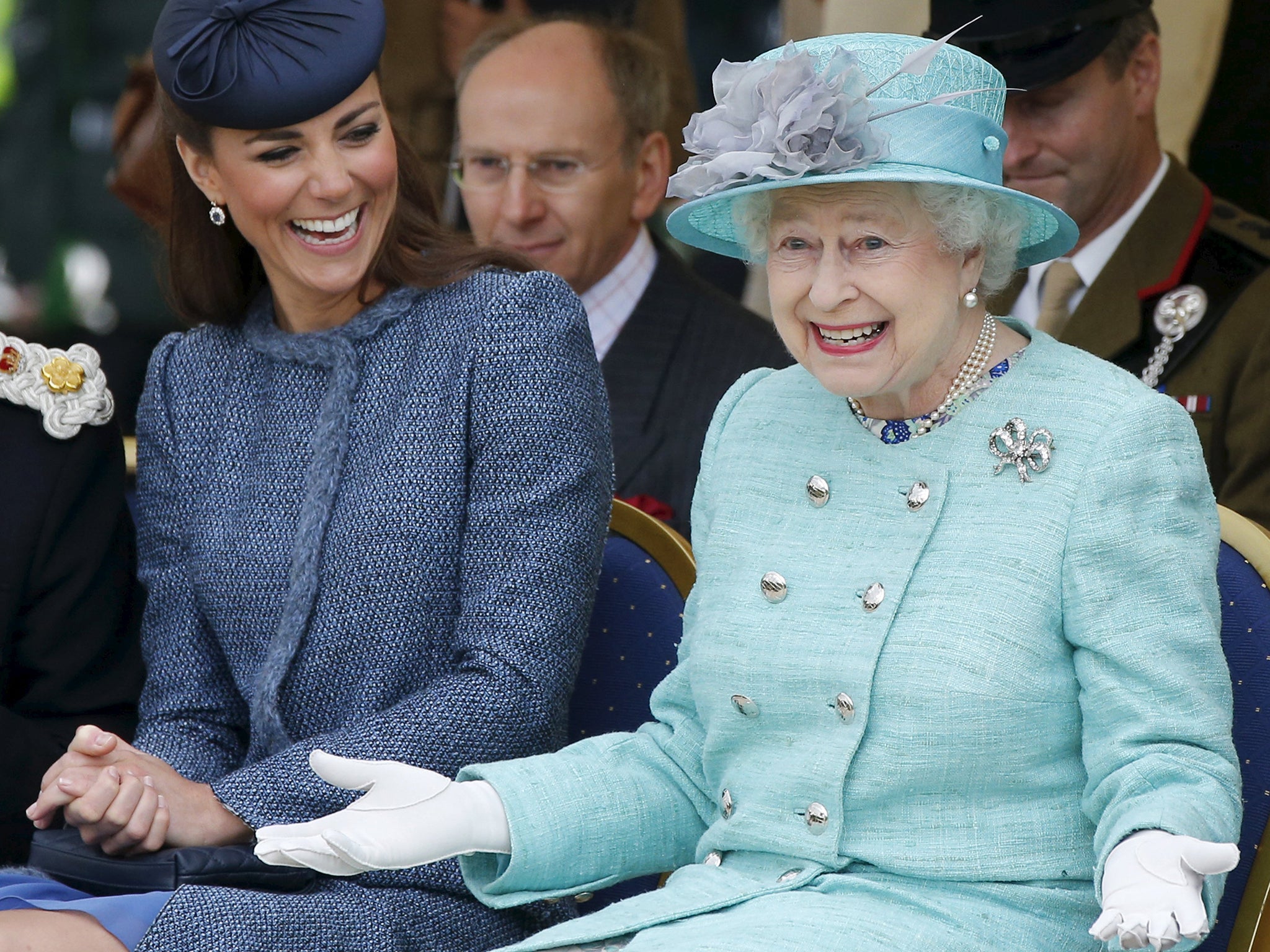 Catherine, Duchess of Cambridge laughs as Queen Elizabeth gestures during a visit to Vernon Park in Nottingham, 2012