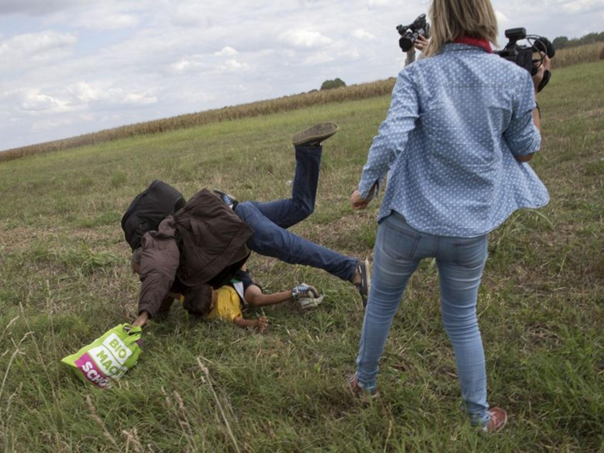 The refugee falls to the ground (Image: REUTERS/Marko Djurica)