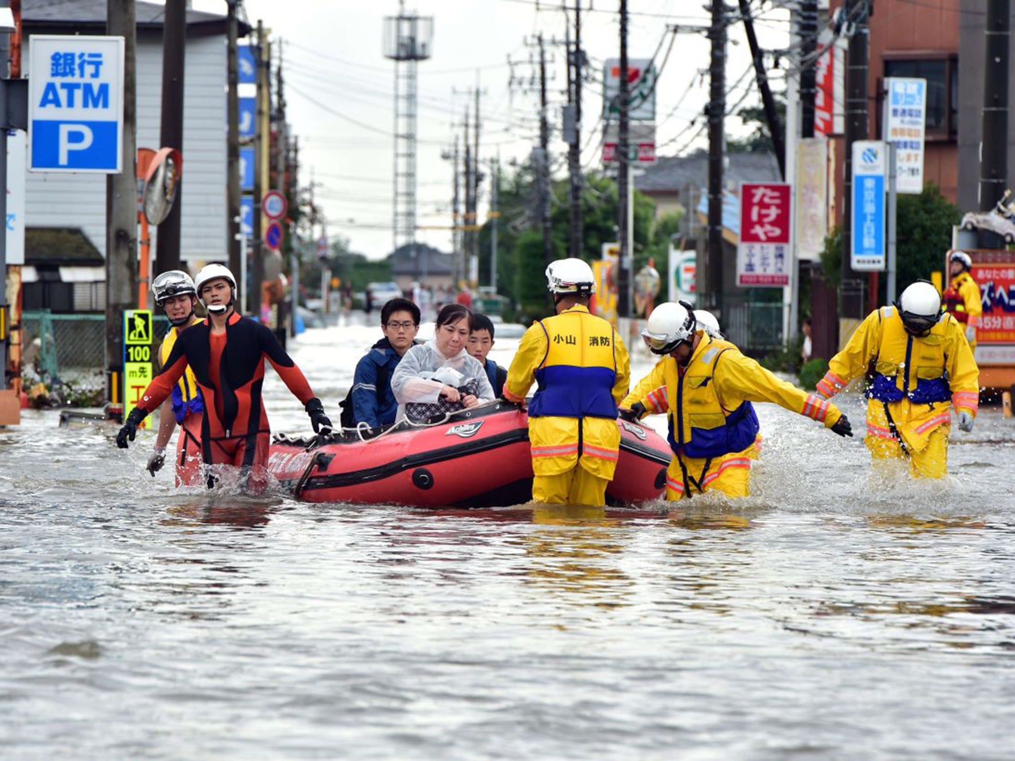 Rescue workers transport evacuees through Oyama, in Tochigi prefecture