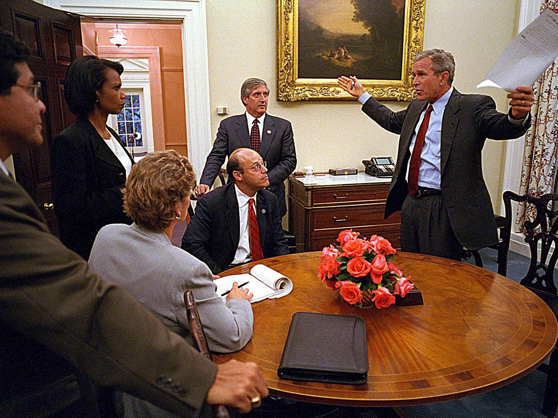 George W Bush addressing staff - including Mr Fleischer (seated) - after finally reaching the White House on September 11 2001