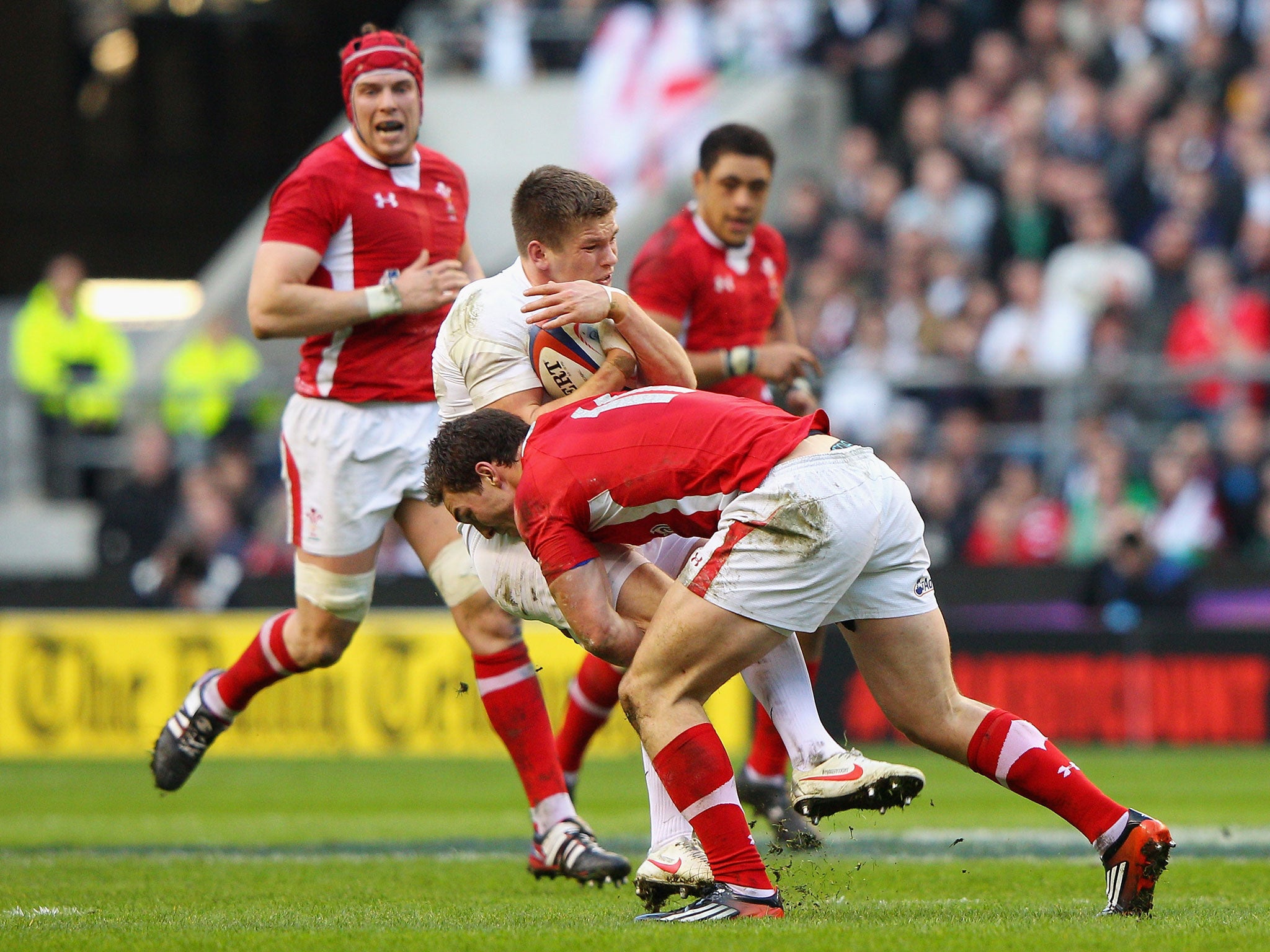 Owen Farrell of England is tackled by George North of Wales in 2012