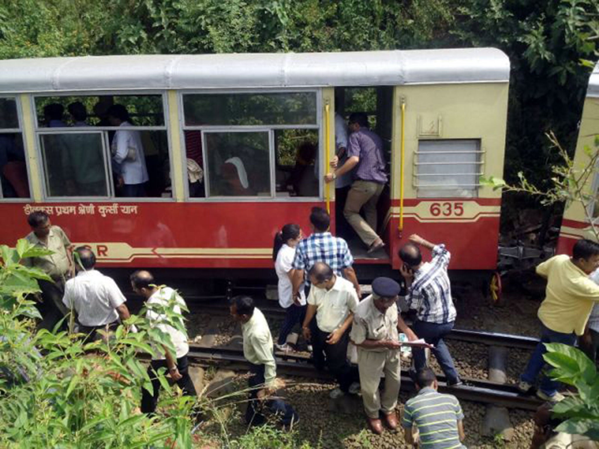 Indian officials investigate at the site of the derailment (AFP)