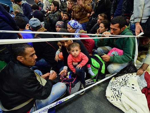 Refugee families wait to be allowed to board trains in Budapest to EU countries including Germany