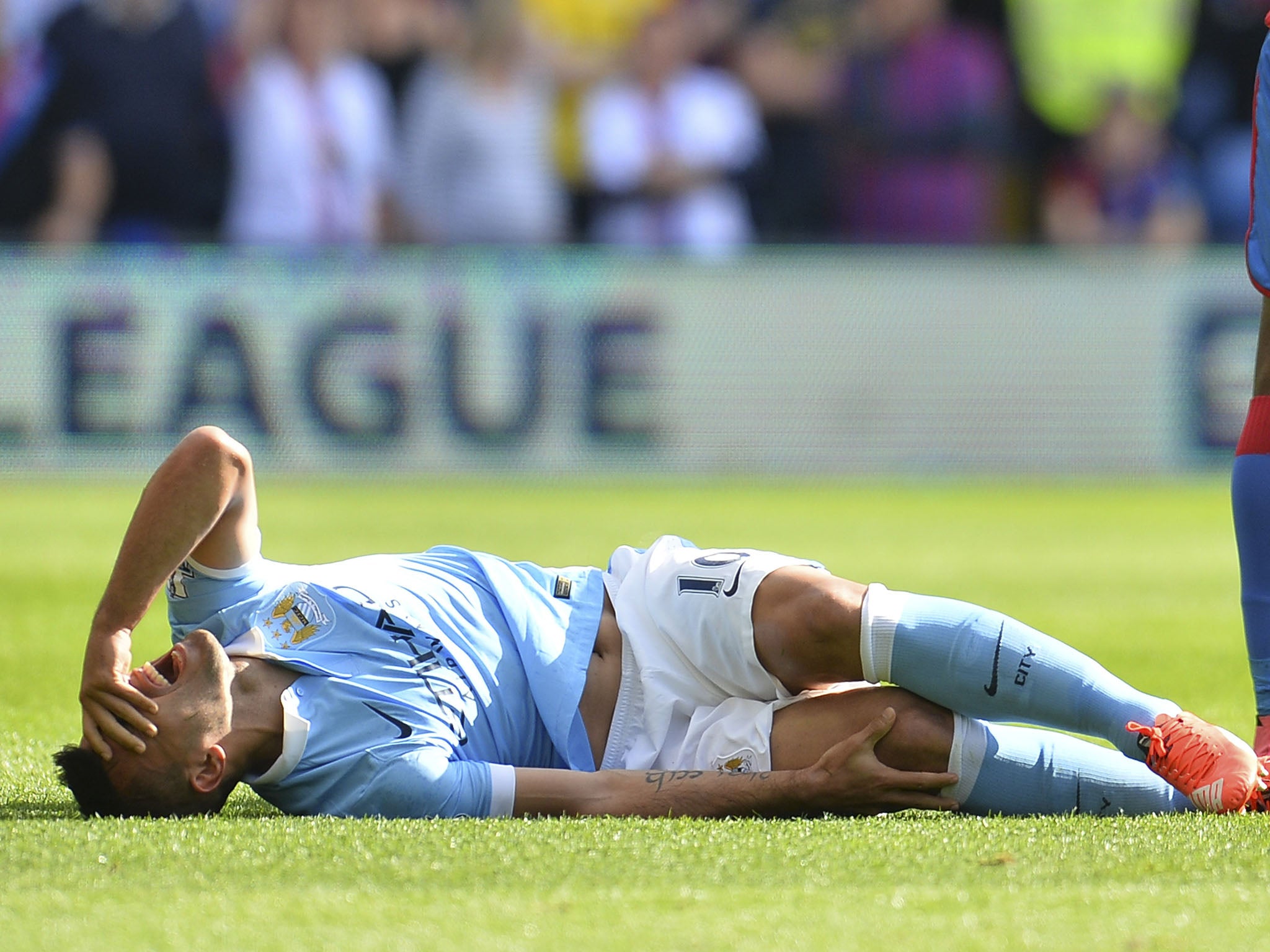 Sergio Aguero lies in agony following Scott Dann's challenge