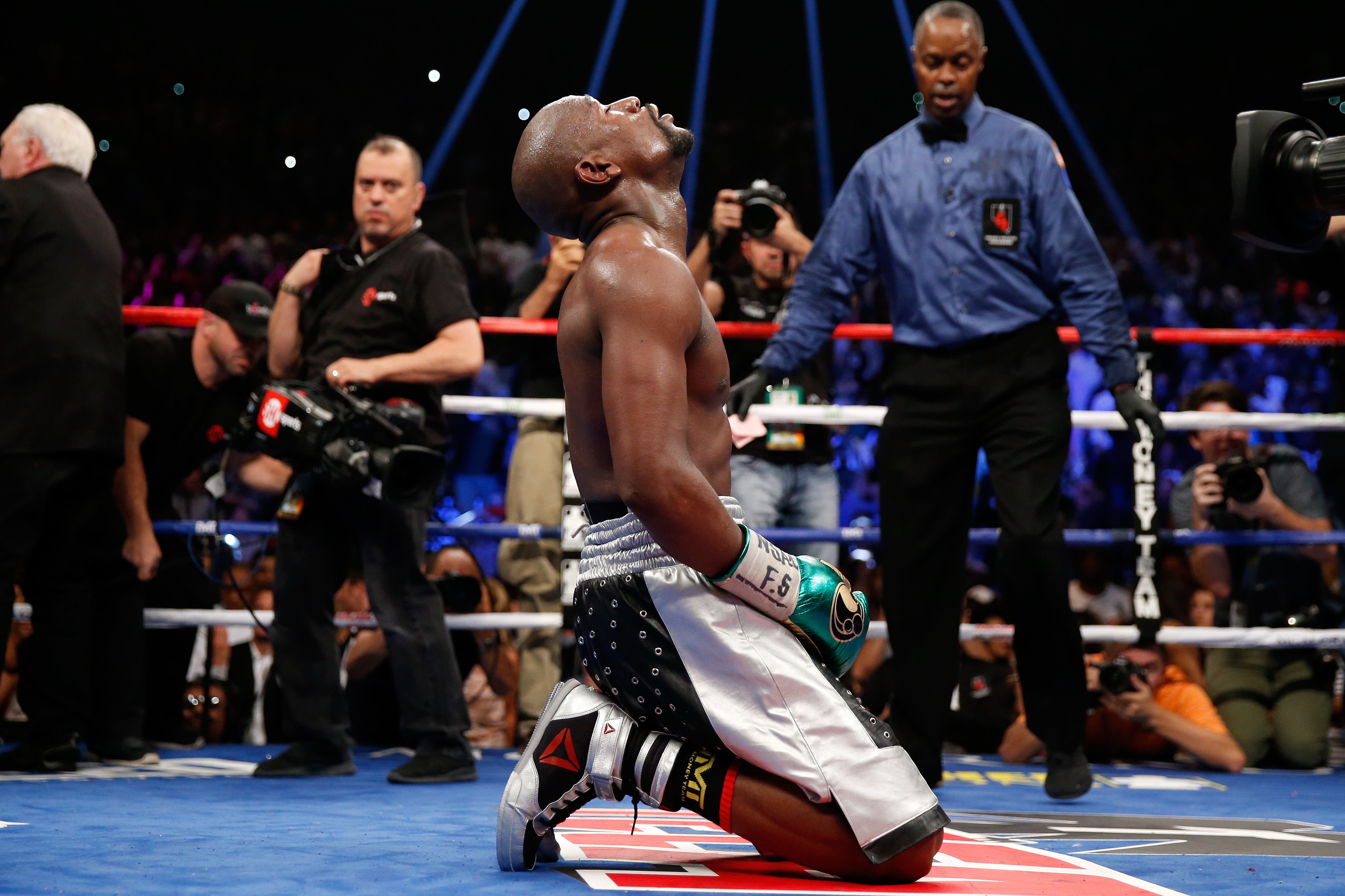 Floyd Mayweather on his knees following his victory over Andre Berto