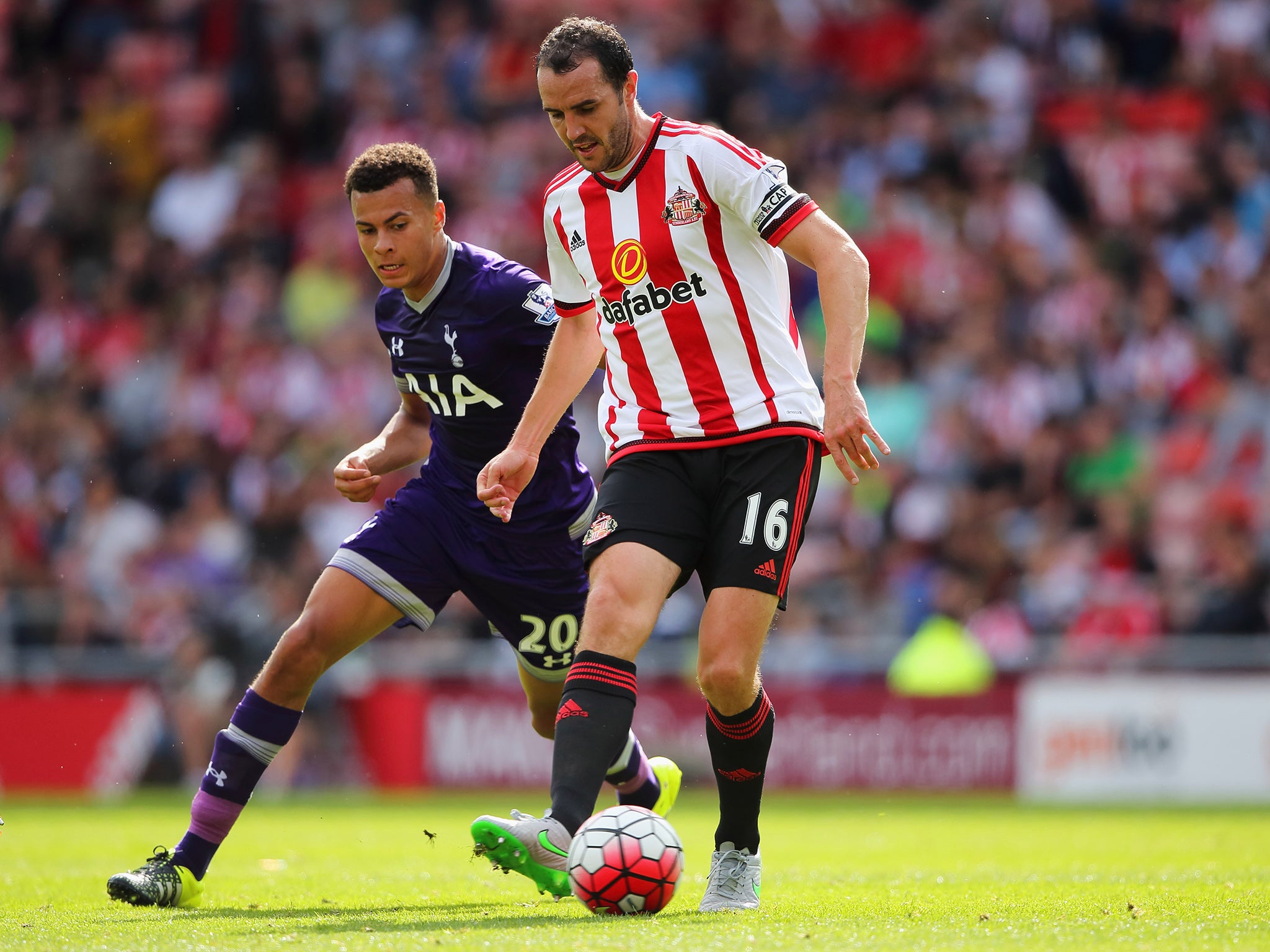 Dell Alli (left) tackles John O'Shea