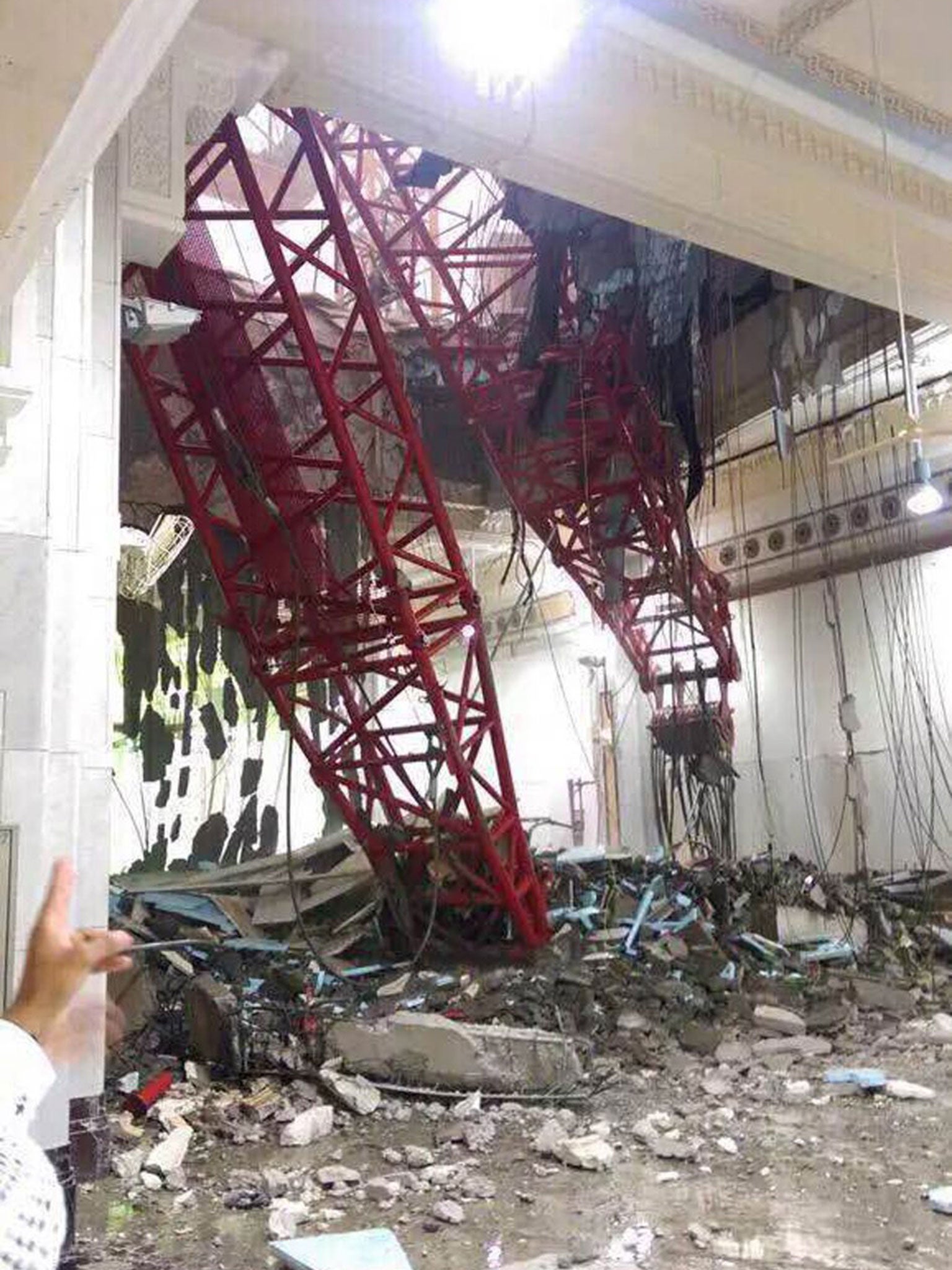 A view from inside the Grand Mosque showing a part of a large crane that collapsed on the mosque