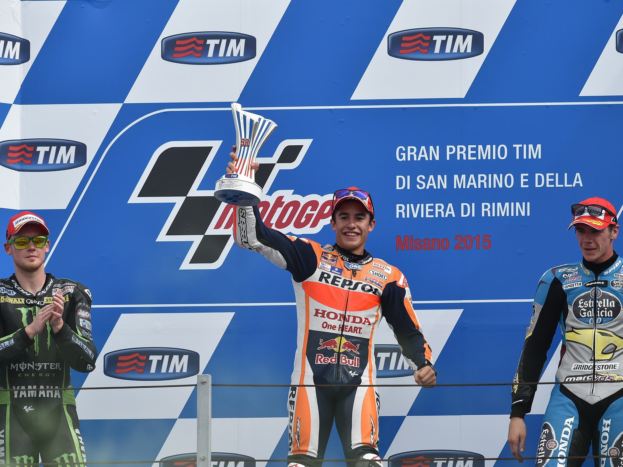 Winner Repsol Honda Team's Spanish rider Marc Marquez (C), second-placed Monster Yamaha Tech 3's British Bradley Smith (L) and GO&FUN Honda Gresini's British rider Scott Redding pose on the podium