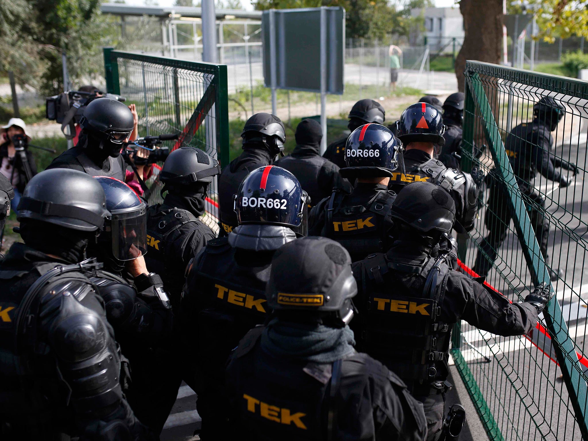 Hungarian riot policemen are deployed at the border crossing with Serbia in Roszke