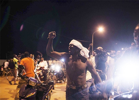 People demonstrate near the presidential palace after soldiers arrested the president and prime minister in Ouagadougou, Burkina Faso