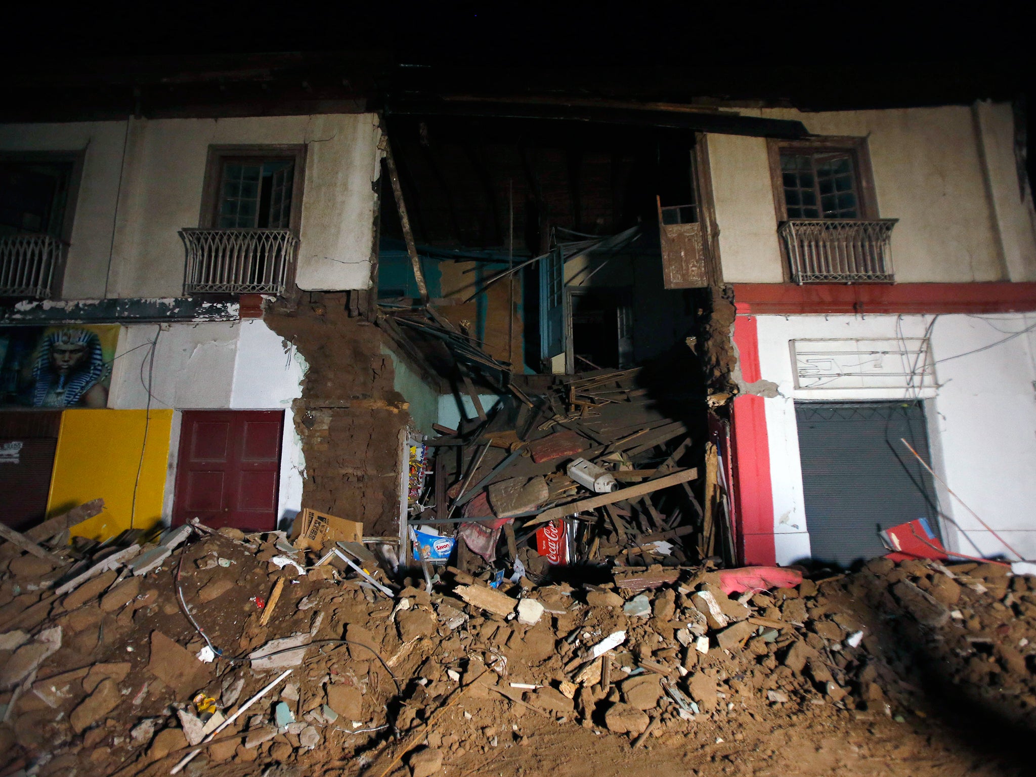 Debris of a destroyed house sit on a street in Illapel