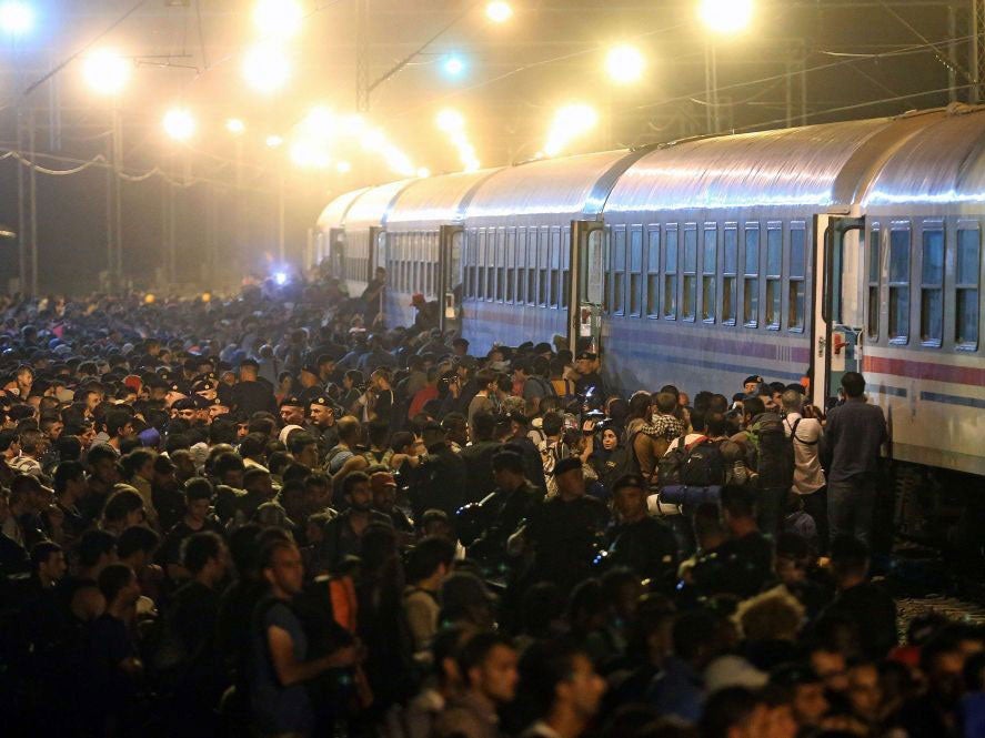 Refugees and migrants boarding a train in the Croatian town of Tovarnik, near the border with Serbia, on Friday night