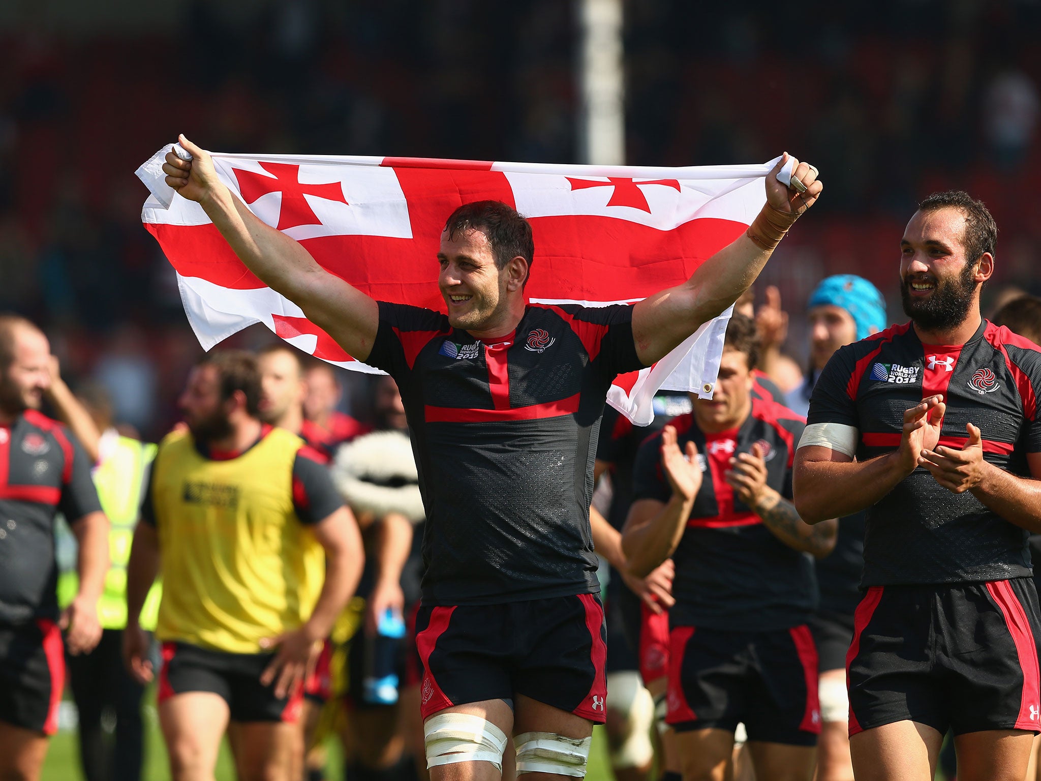 Georgia celebrate their victory over Tonga in Pool C