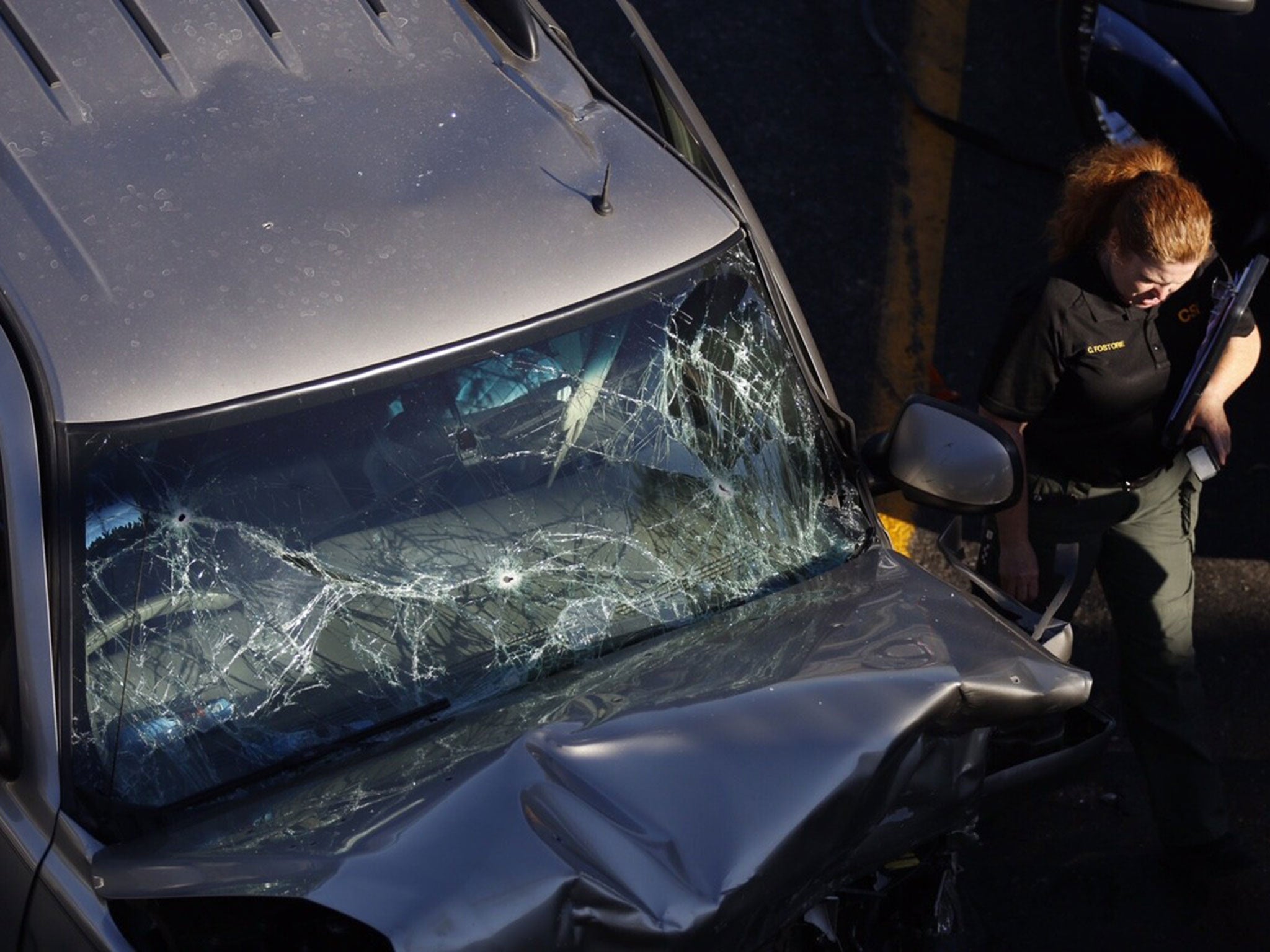 The windshield of a robbery suspect's car is shattered by bullets after being shot from a San Bernardino County sheriff's helicopter in California