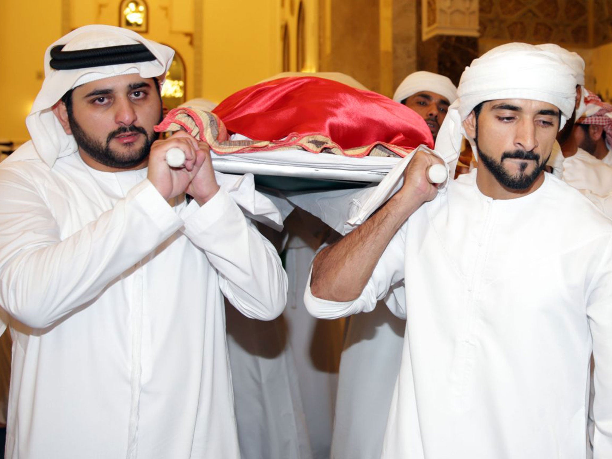 Crown prince of Dubai Sheikh Hamdan bin Mohammed (right) and the emirate's deputy ruler Sheikh Maktoum bin Mohammed, carry the body of their late brother