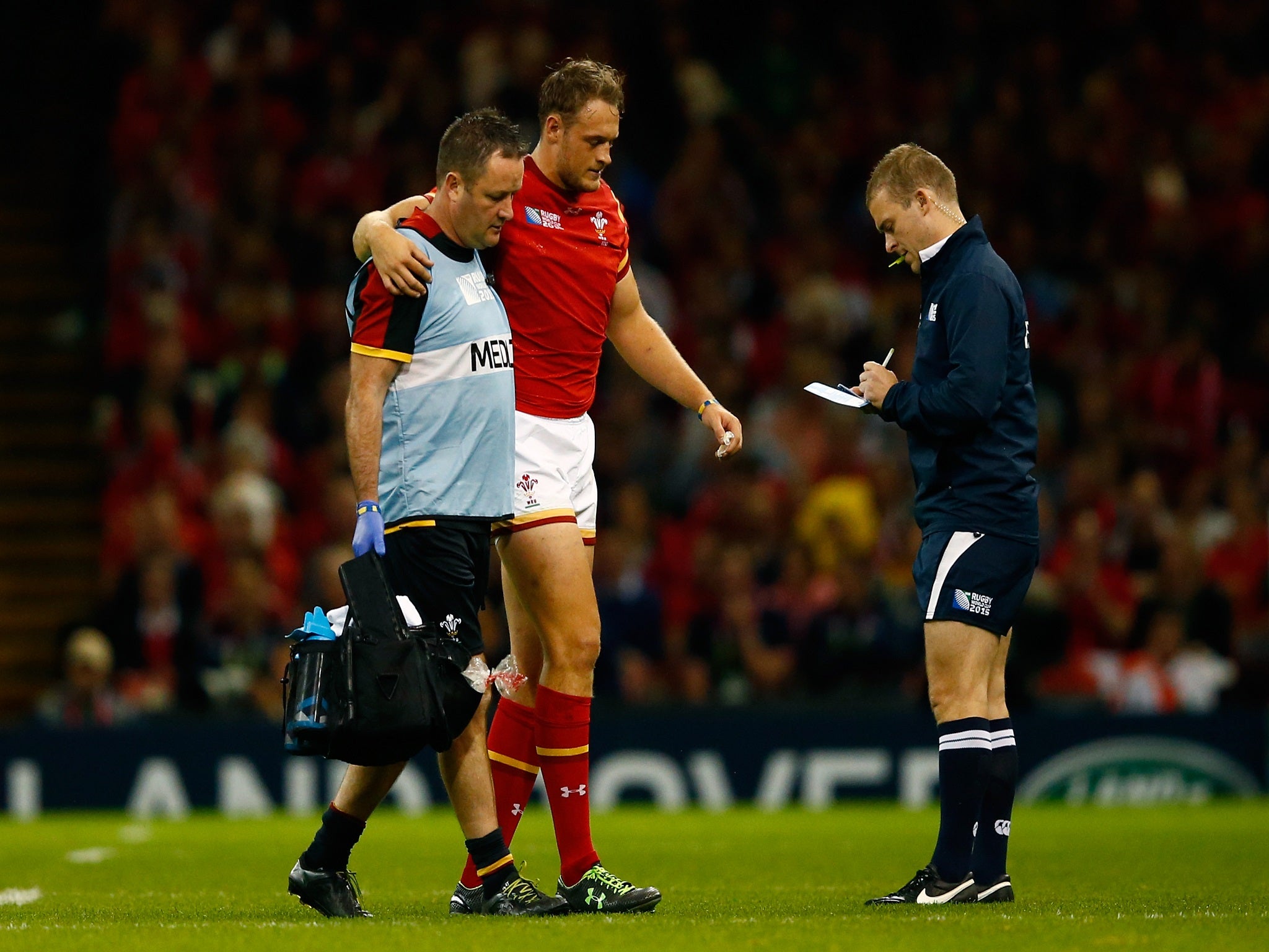 Cory Allen is helped off the field during Wales' win over Uruguay