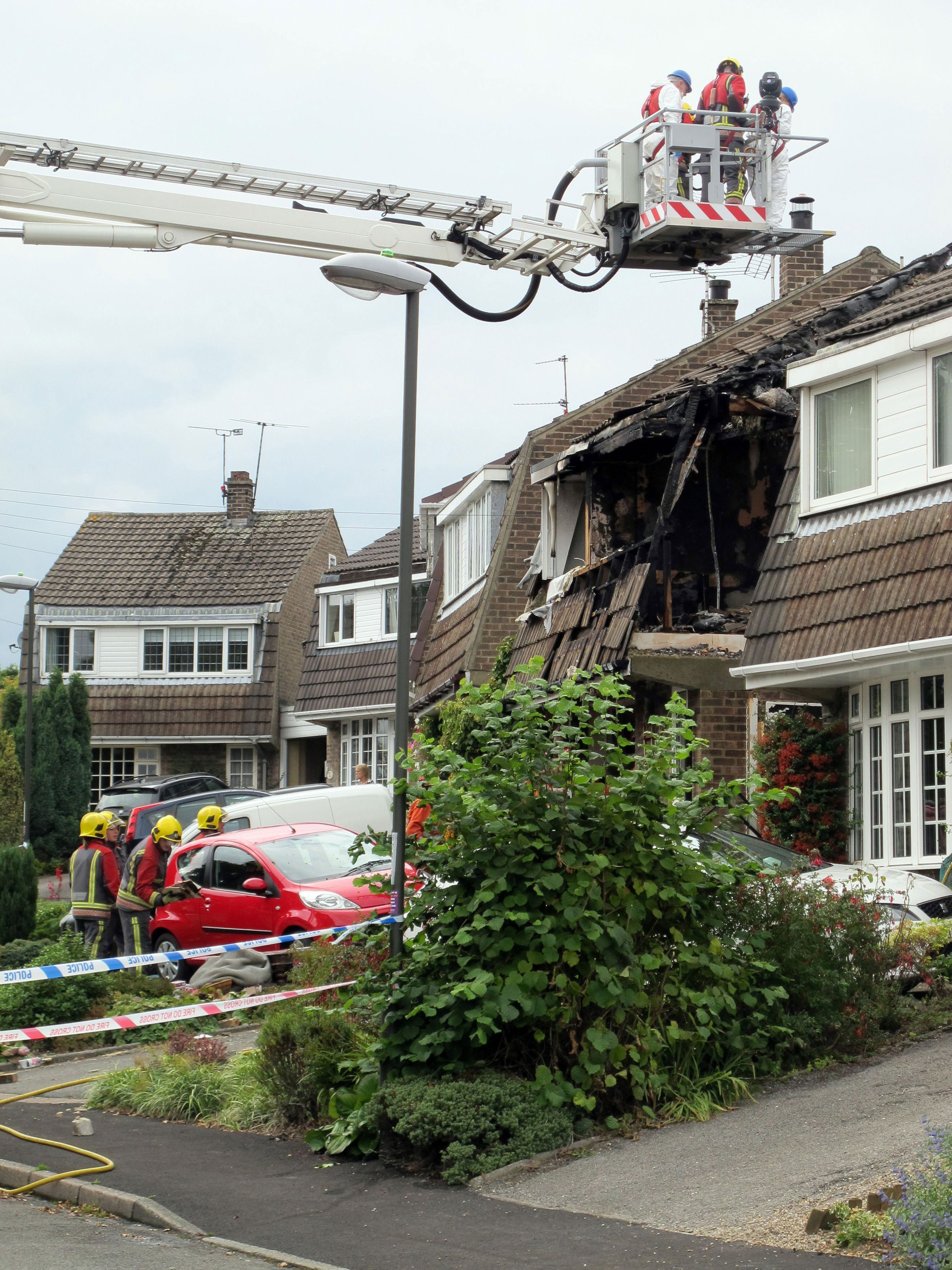 Fire crews at the house in Riddings, near Alfreton where two people died in a fierce house fire