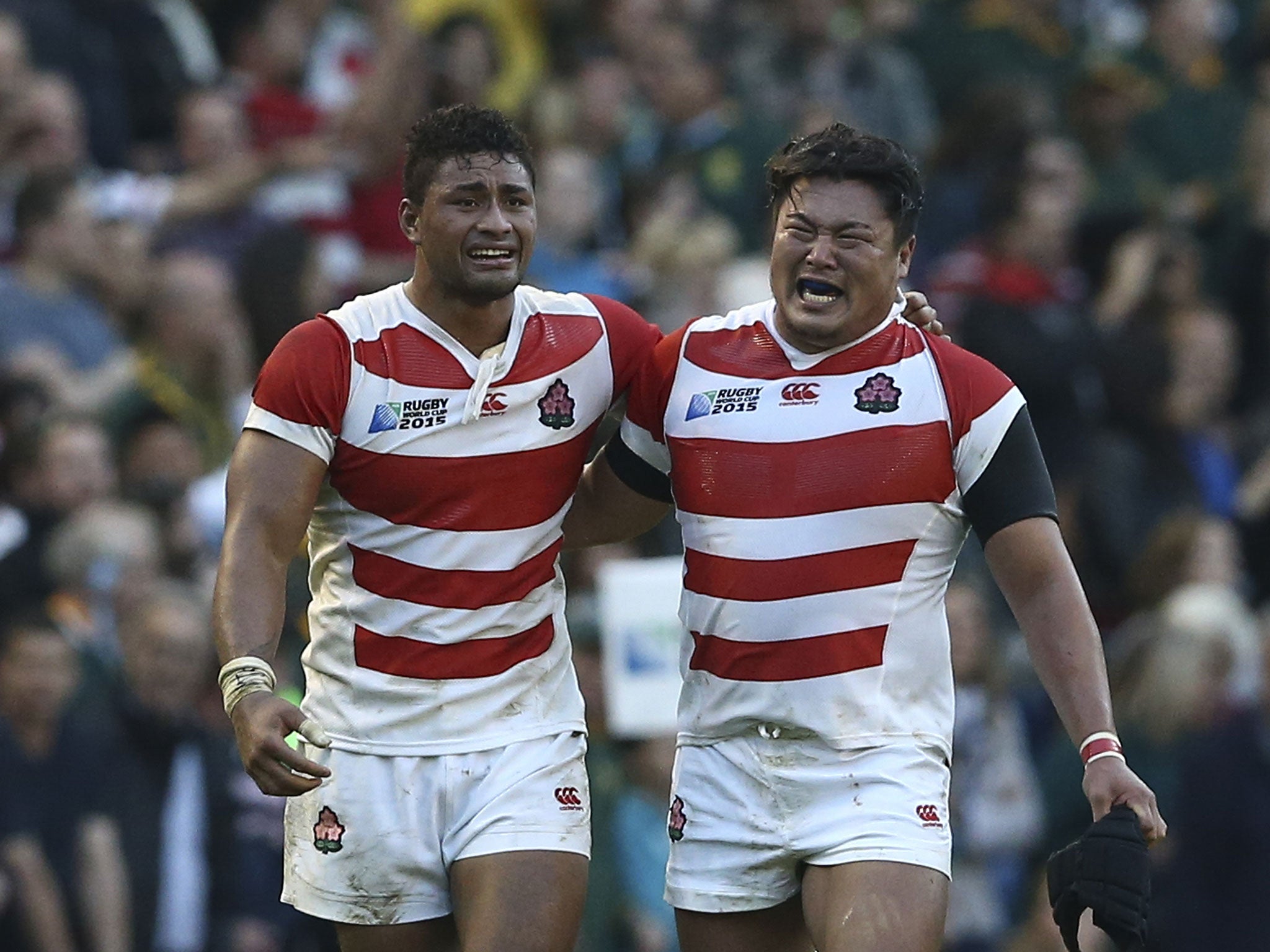 Japan's Amanaki Mafi (L) and Japan's Hiroshi Yamashita (R) react after their victory