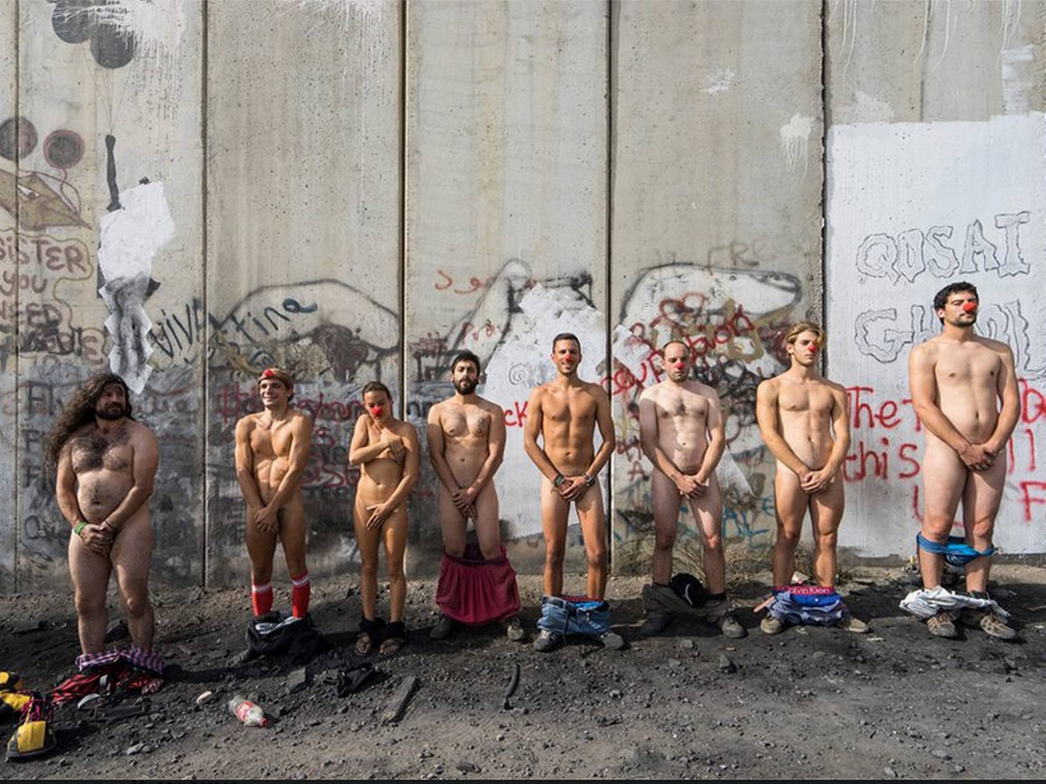 Members of Pallasos en Rebedia, which translates to Clowns in Rebellion, at the wall separating Israel with the West Bank