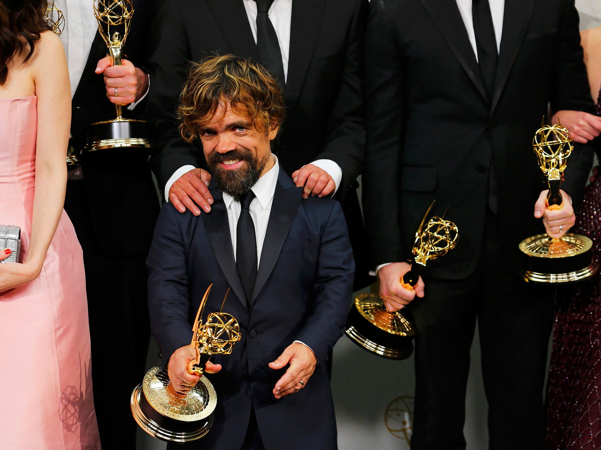 Actor Peter Dinklage and the cast of HBO's "Game of Thrones" pose backstage with their Outstanding Drama Series award during the 67th Primetime Emmy Awards in Los Angeles, California