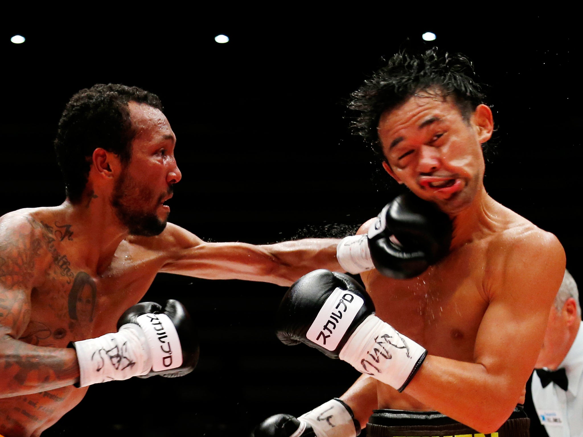 Japanese champion Shinsuke Yamanaka, right, gets a punch from Panama's challenger Anselmo Moreno in the eighth round of their WBC bantamweight boxing title match in Tokyo, Japan. Yamanaka defended his title by a 2-1 decision