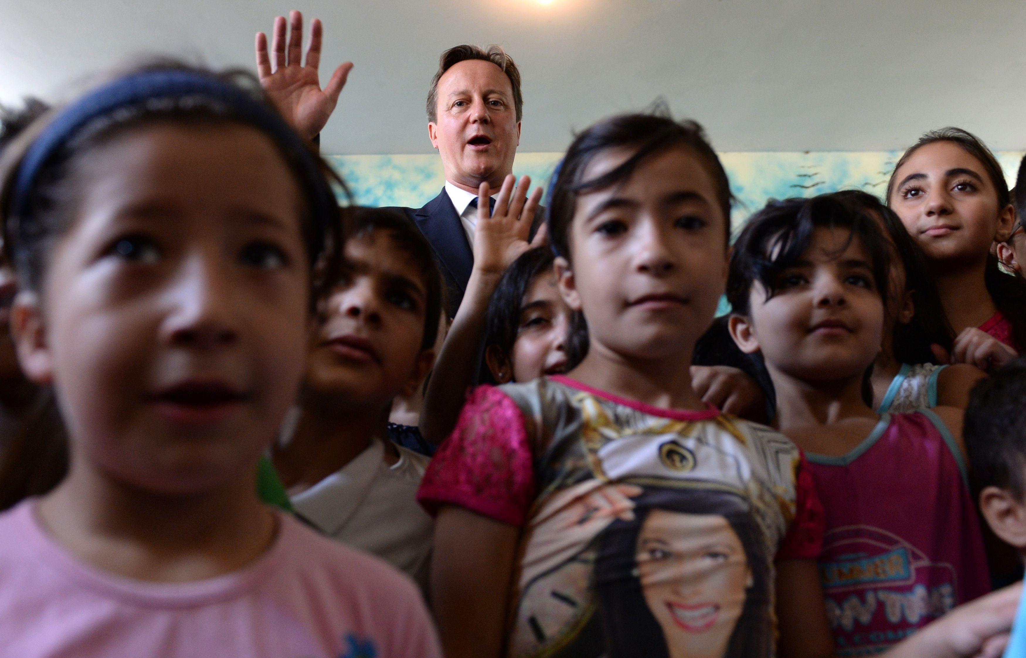 David Cameron on a visit to a school in Beirut, Lebanon, where many Syrian refugees have fled (PA)