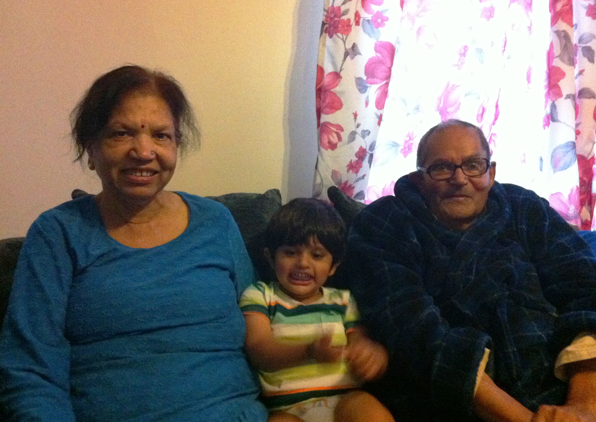 The Sharmas pictured with one of their grandchildren