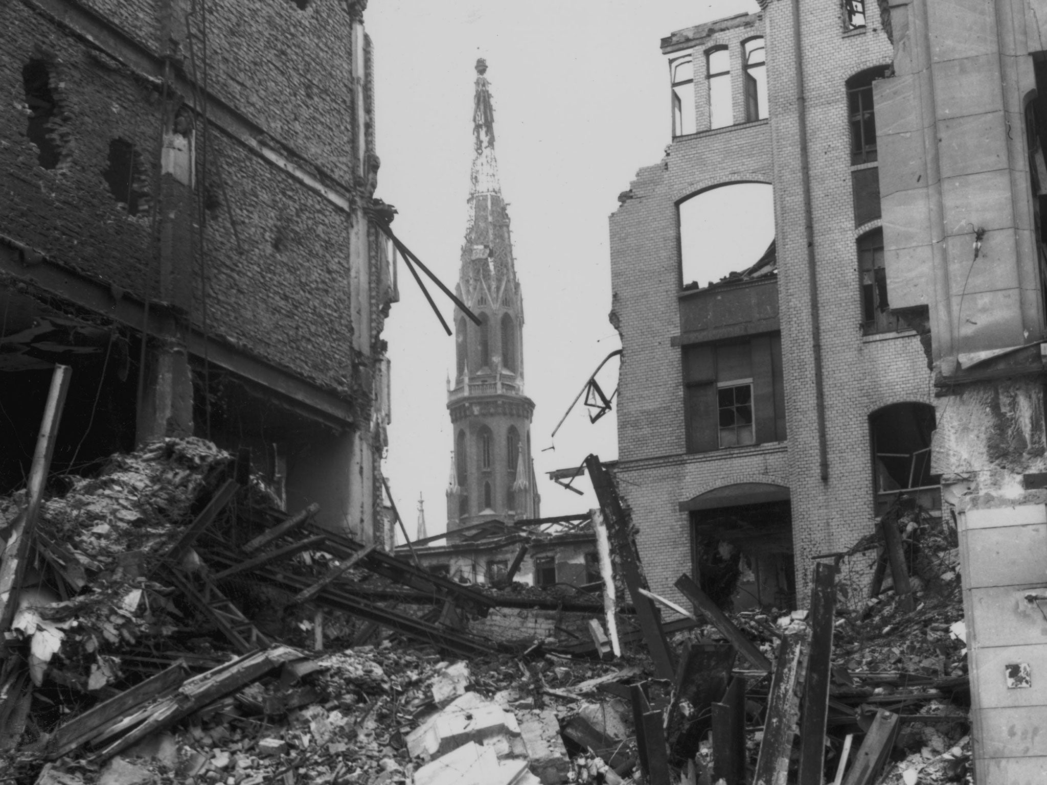 Lack of remorse: St Peter’s Church can be seen through the ruins of the Spittlemarkt Strasse area of defeated Berlin