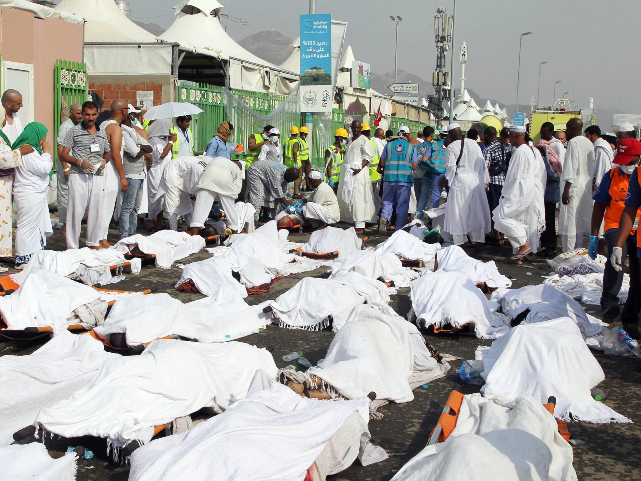 Muslim pilgrims and rescuers gather around people who were crushed by overcrowding in Mina, Saudi Arabia during the annual hajj pilgrimage