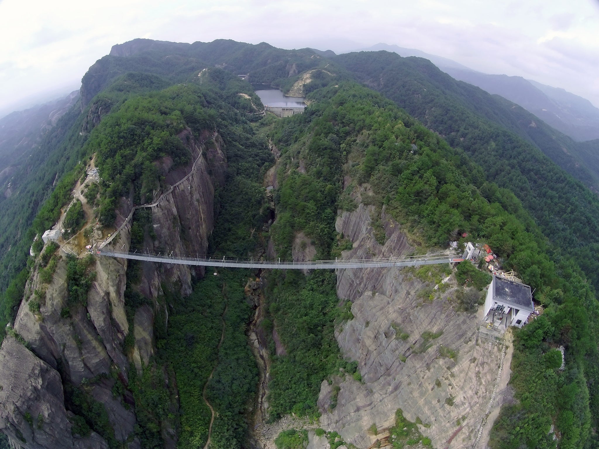 Teh glass-bottomed suspension bridge in the Shiniuzhai National Geopark in Pingjiang, China