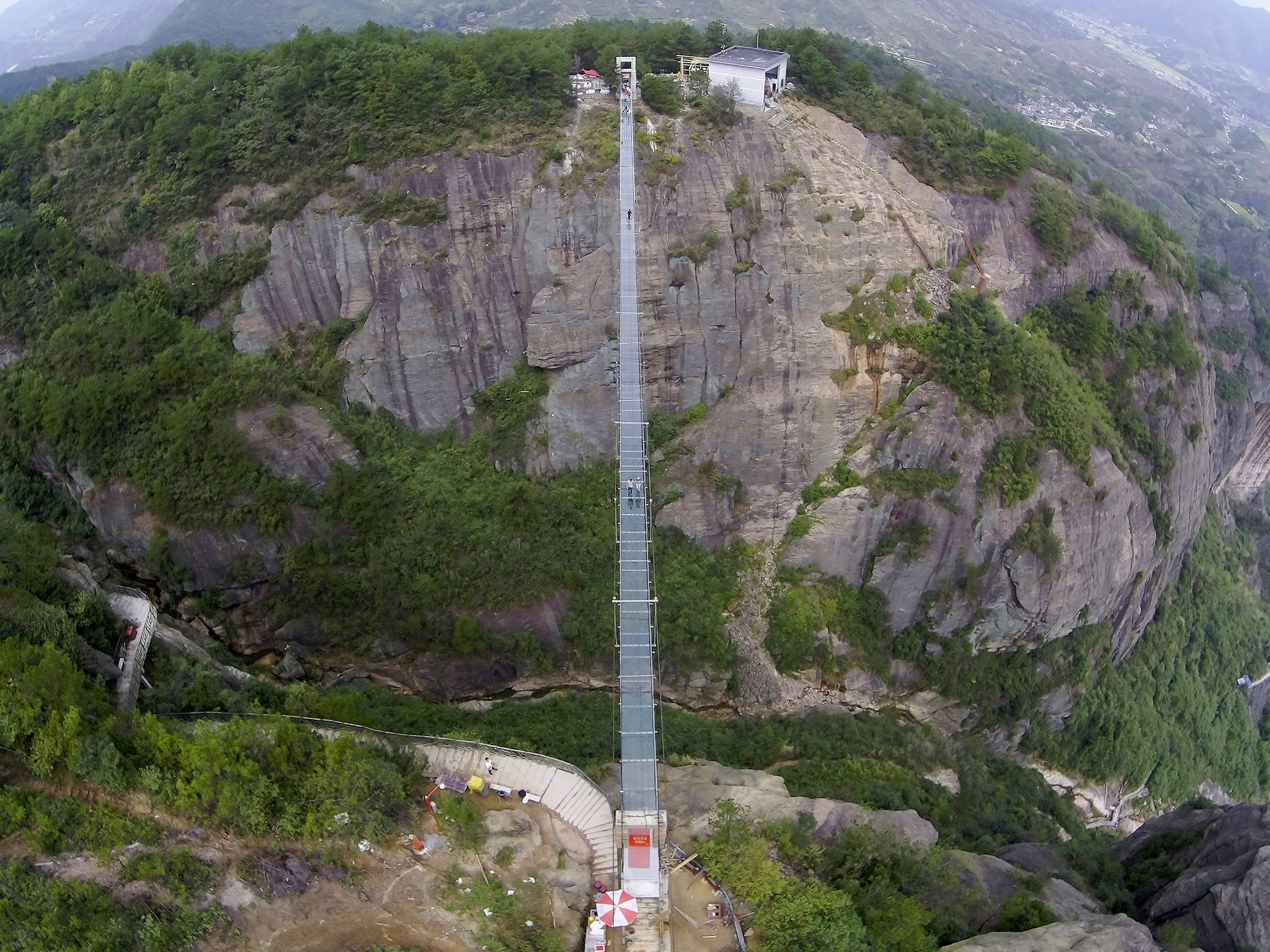 An aerial view shows a glass suspension bridge at the Shiniuzhai National Geo-park in Pinging county, Hunan province, China