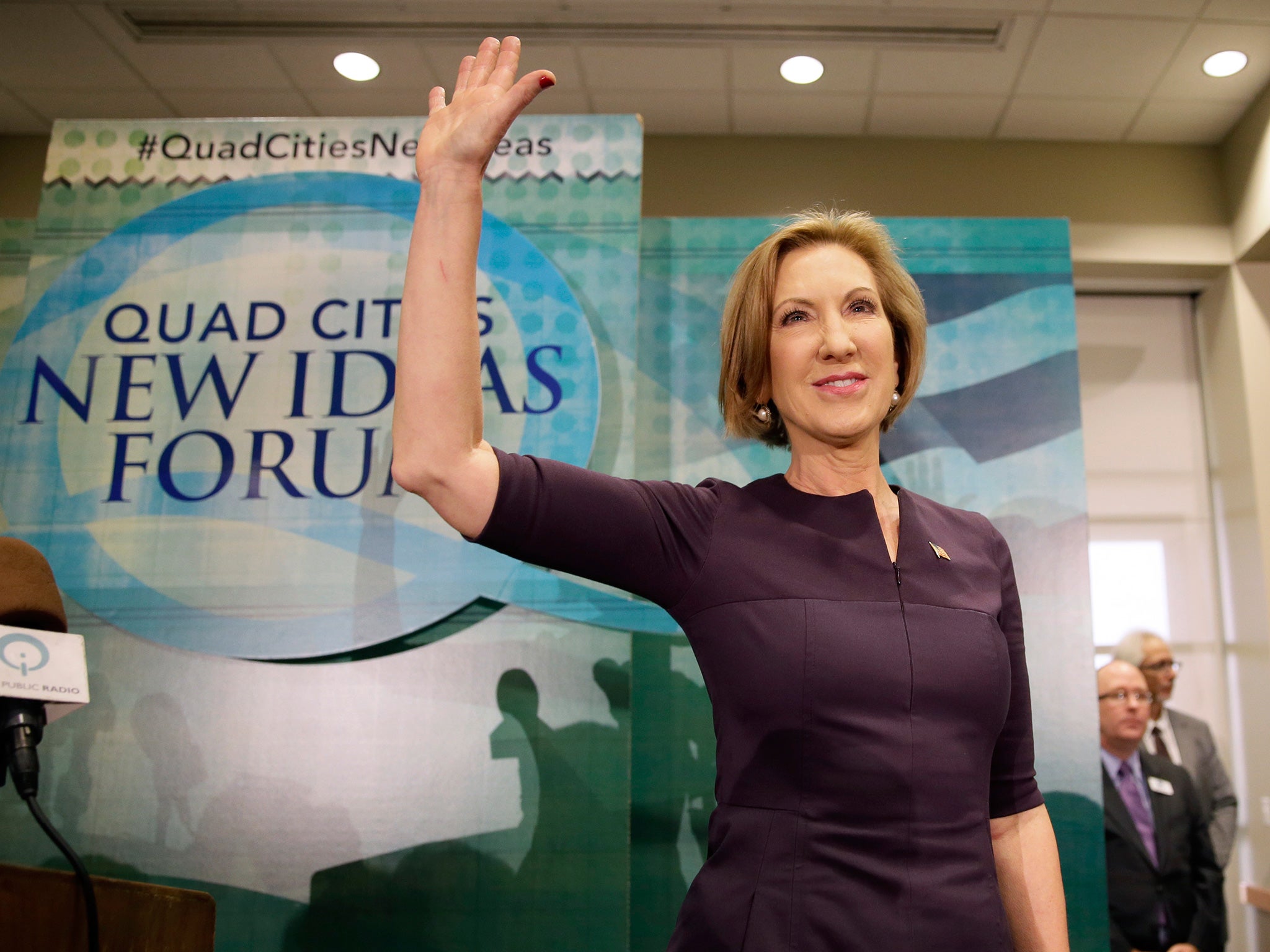 Carly Fiorina waves to supporters after speaking at the Quad Cities New Ideas Forum