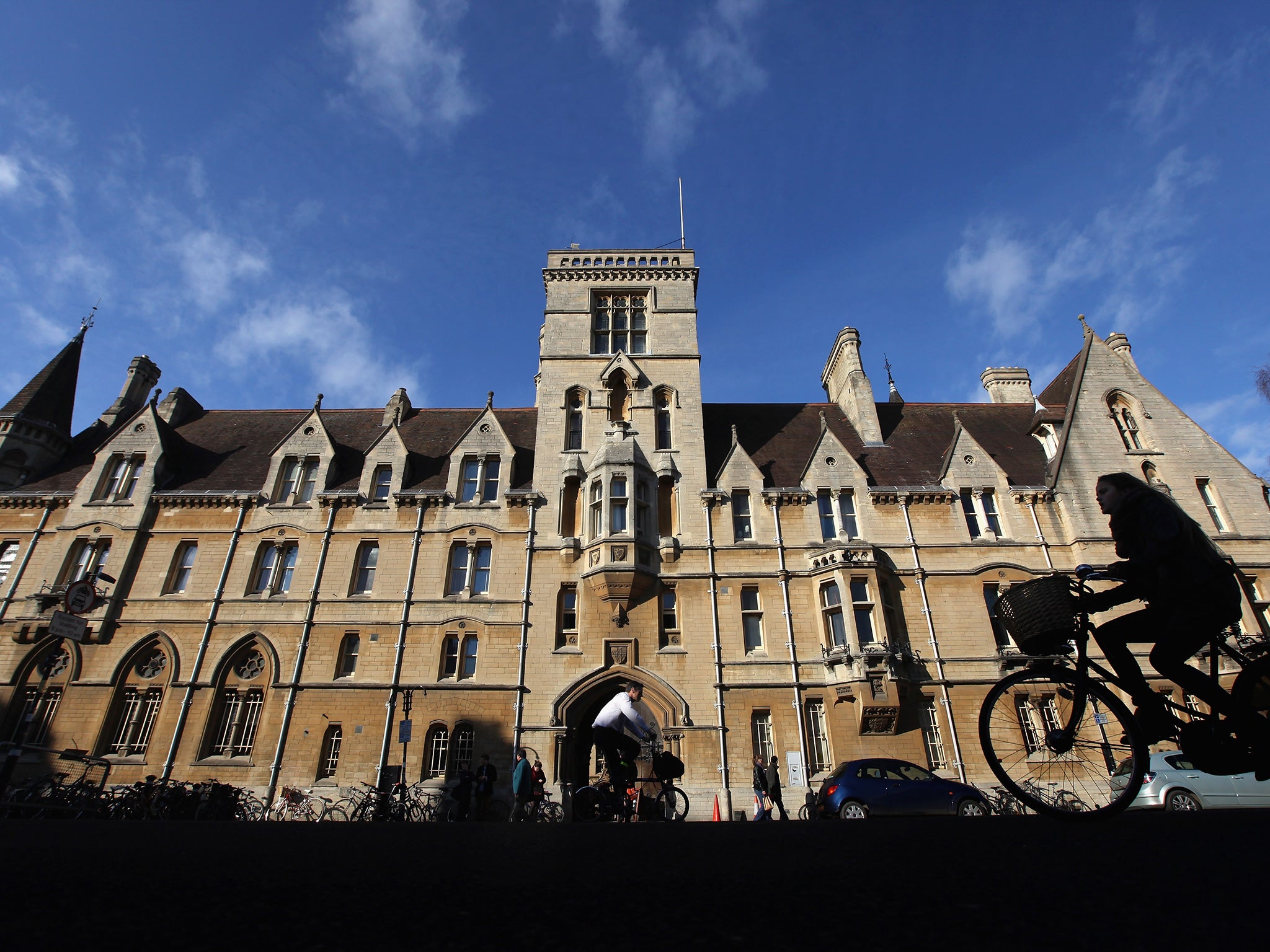 A woman rides past Balliol College