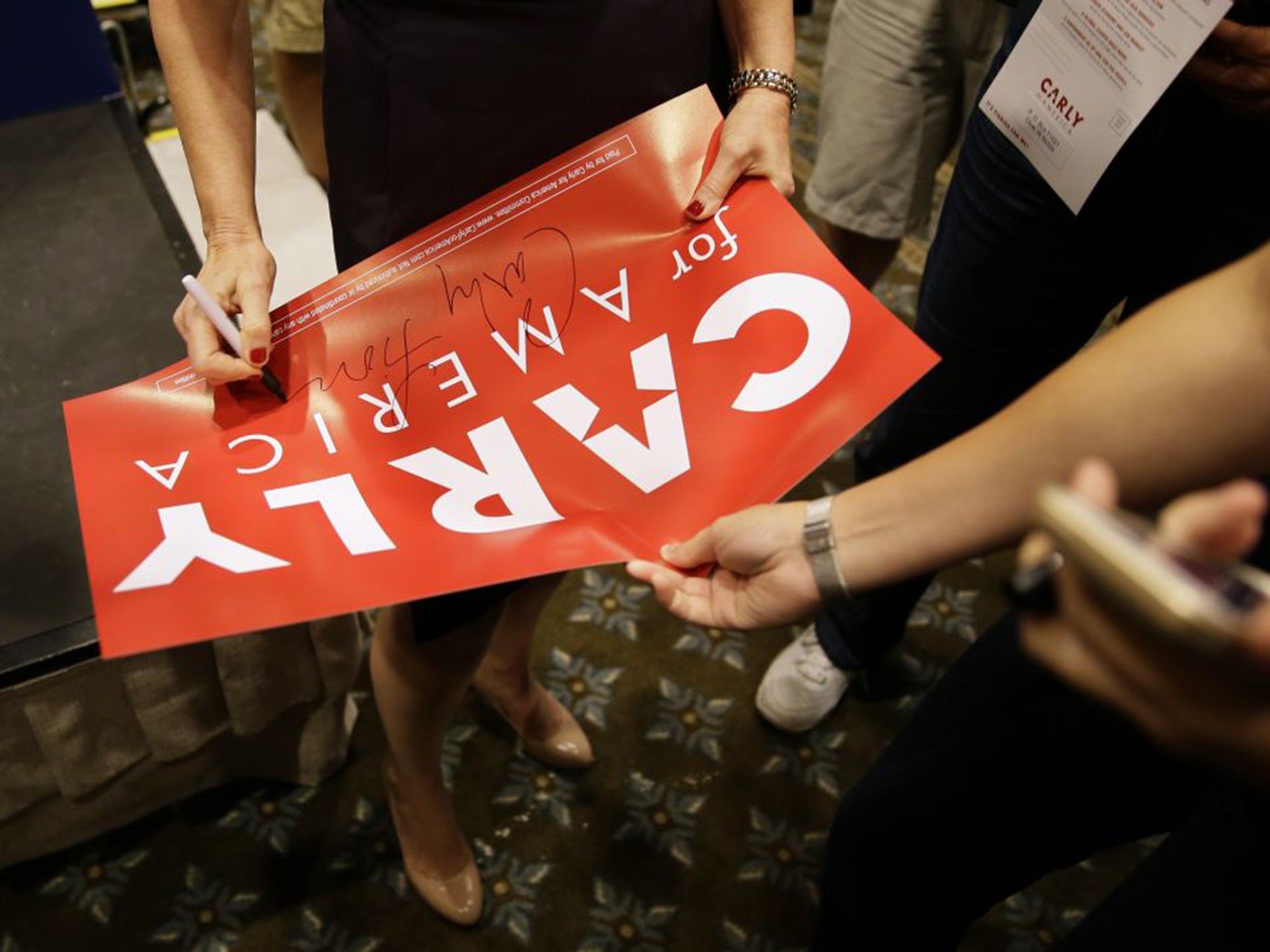 Republican presidential candidate Carly Fiorina signs an autograph