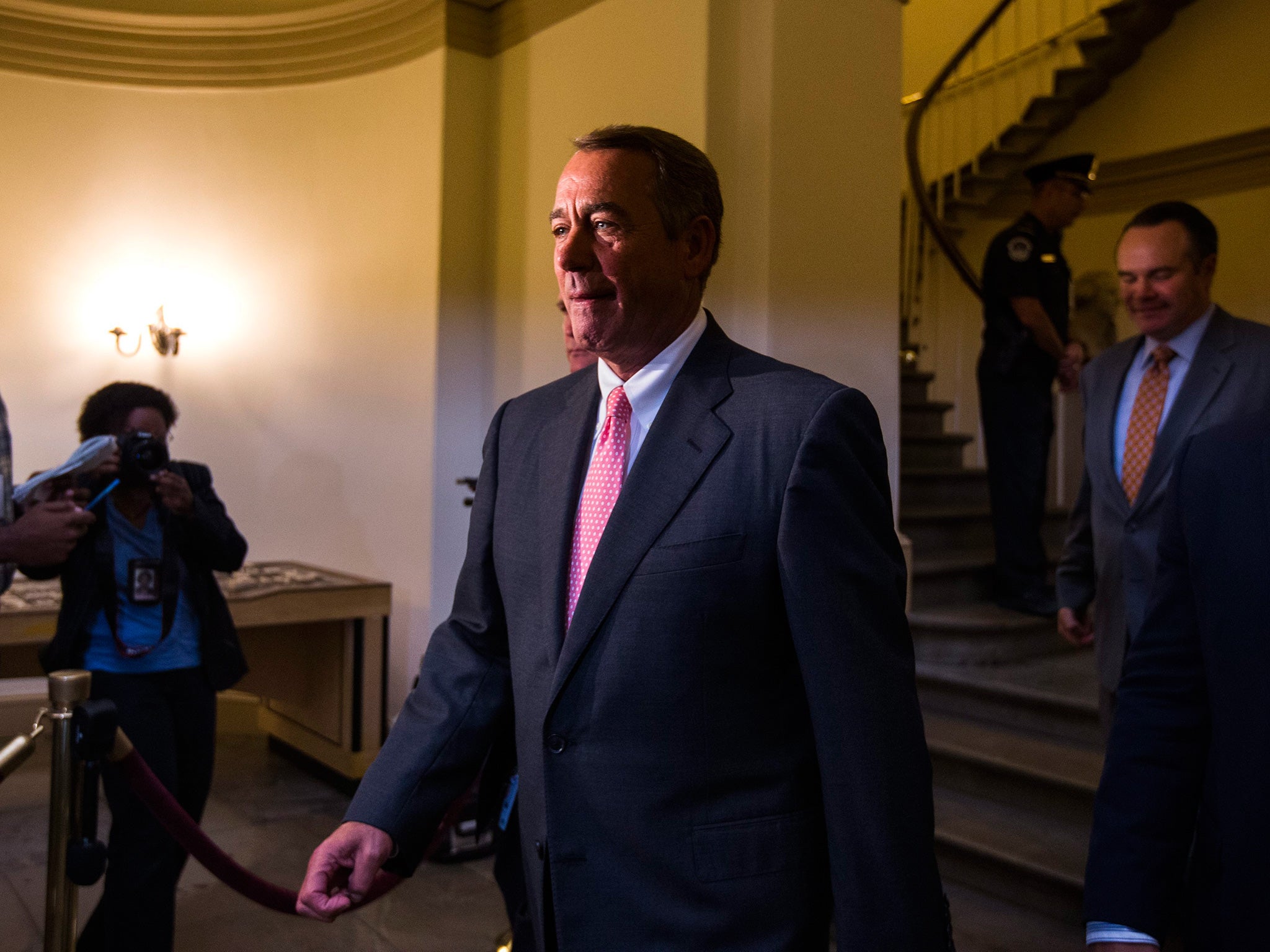 John Boehner walks through the hallways of the U.S. Capitol to a press conference at which he announced his resignation