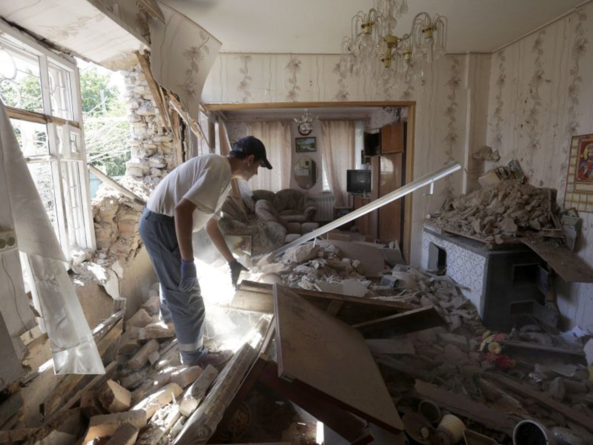 A man inspects his shelled home in Donetsk last month