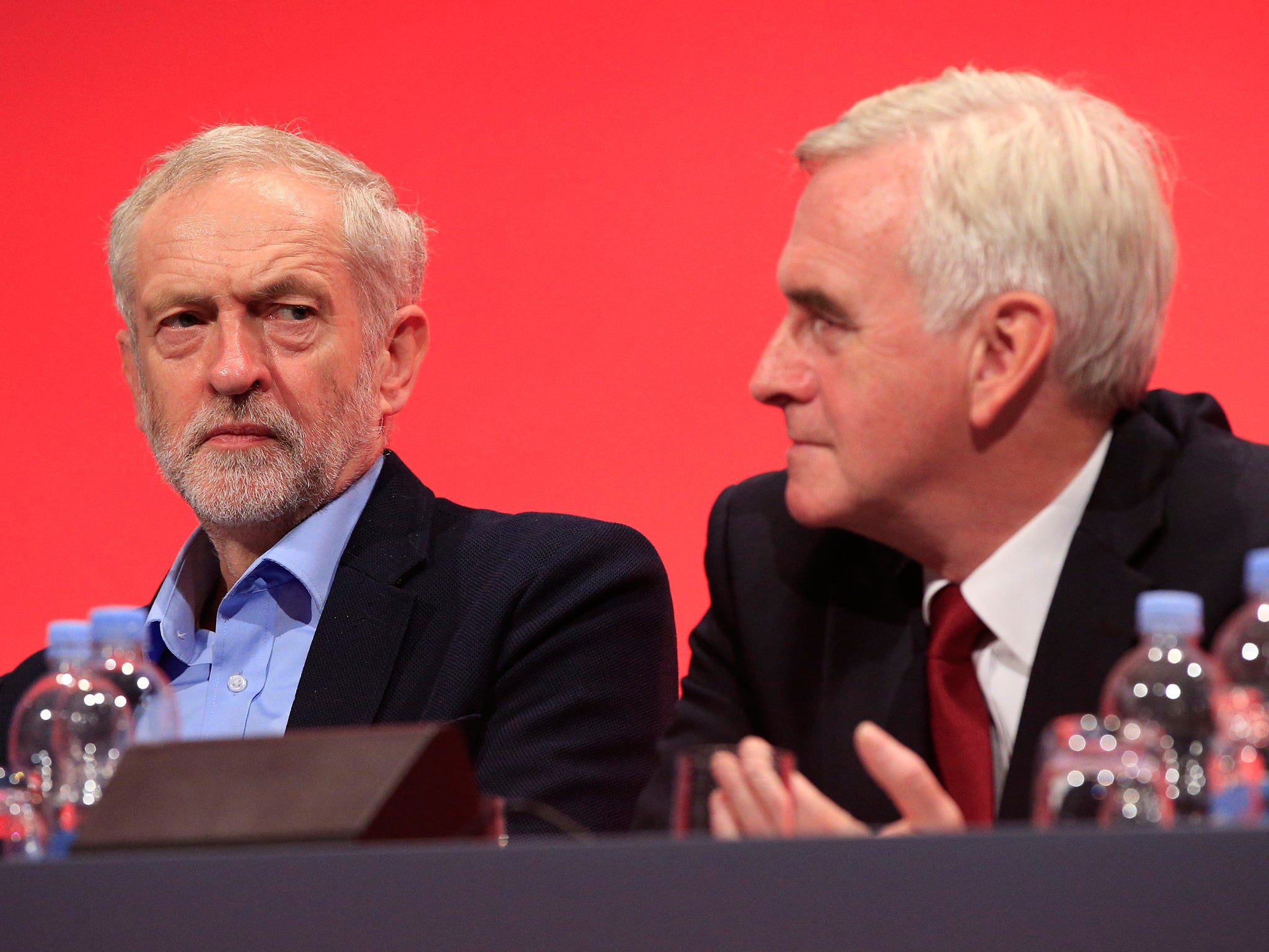 Labour leader Jeremy Corbyn (left) looks toward shadow chancellor John McDonnell on stage during the second day of the Labour Party conference in Brighton, Sussex