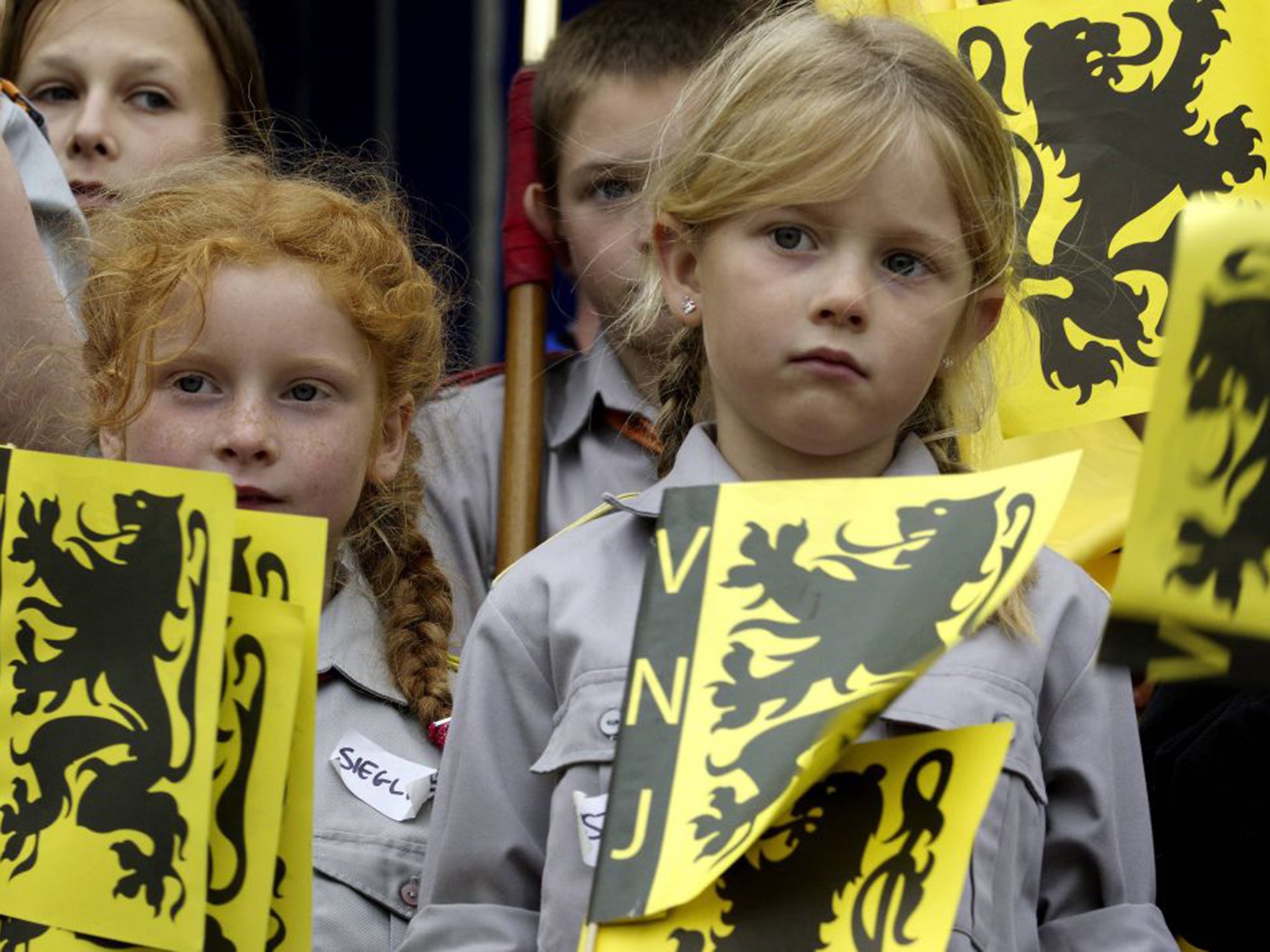 Children hold Flemish flags in Belgium, one of many divided countries